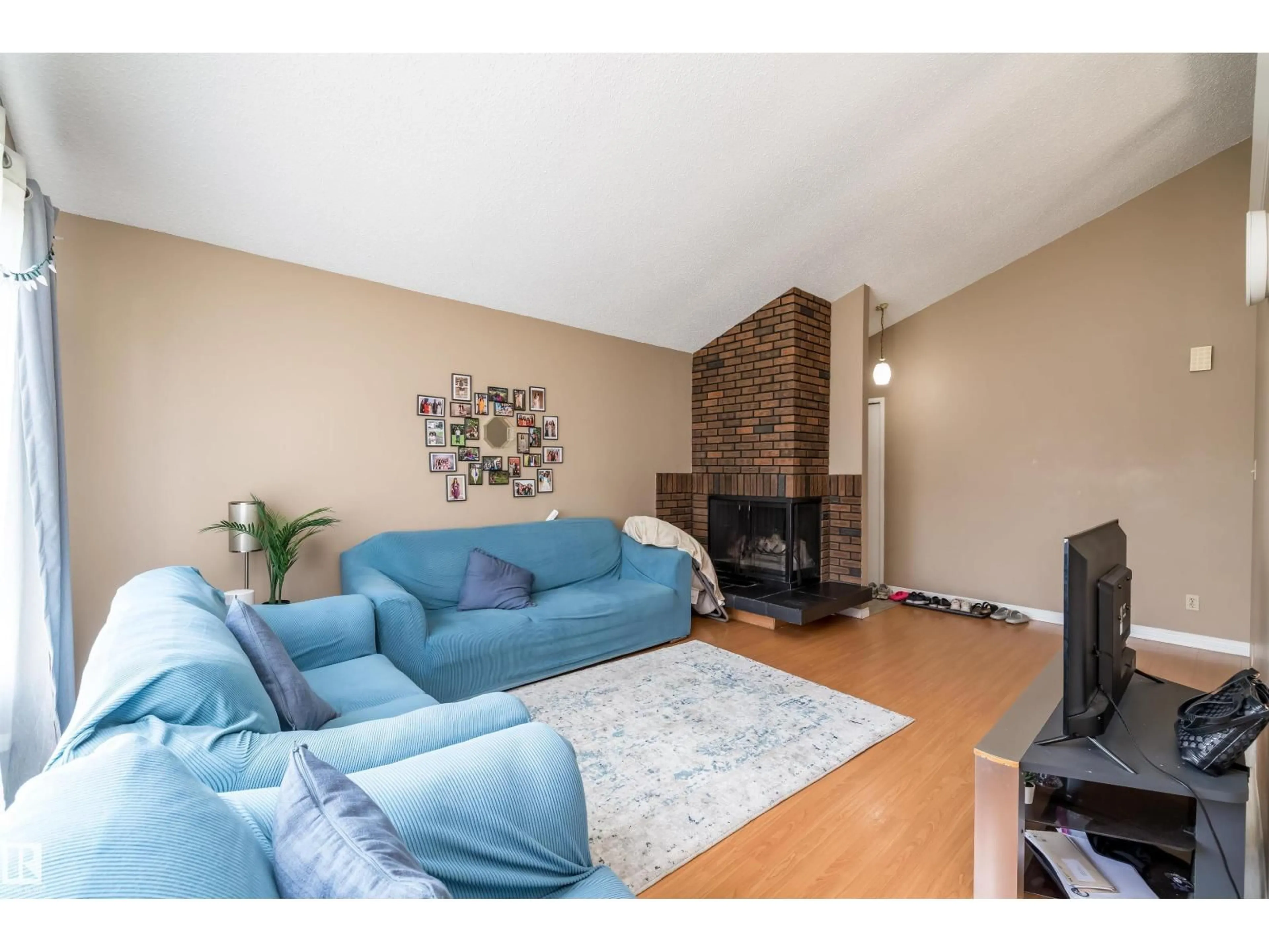 Living room with furniture, wood/laminate floor for 3620 42A AV, Edmonton Alberta T6L4N7