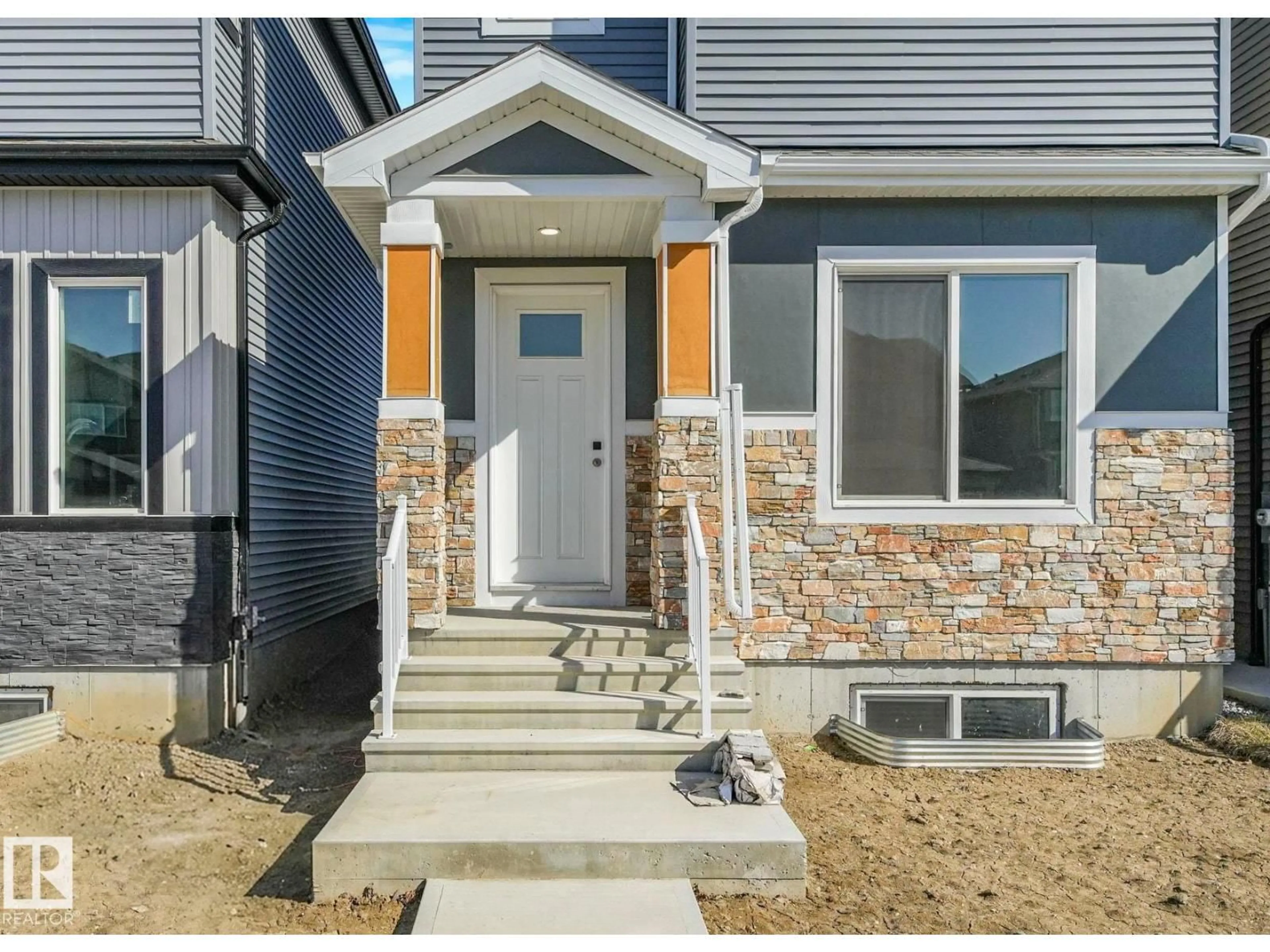 Home with vinyl exterior material, street for 838 NORTHERN HARRIER LN, Edmonton Alberta T5R2V5