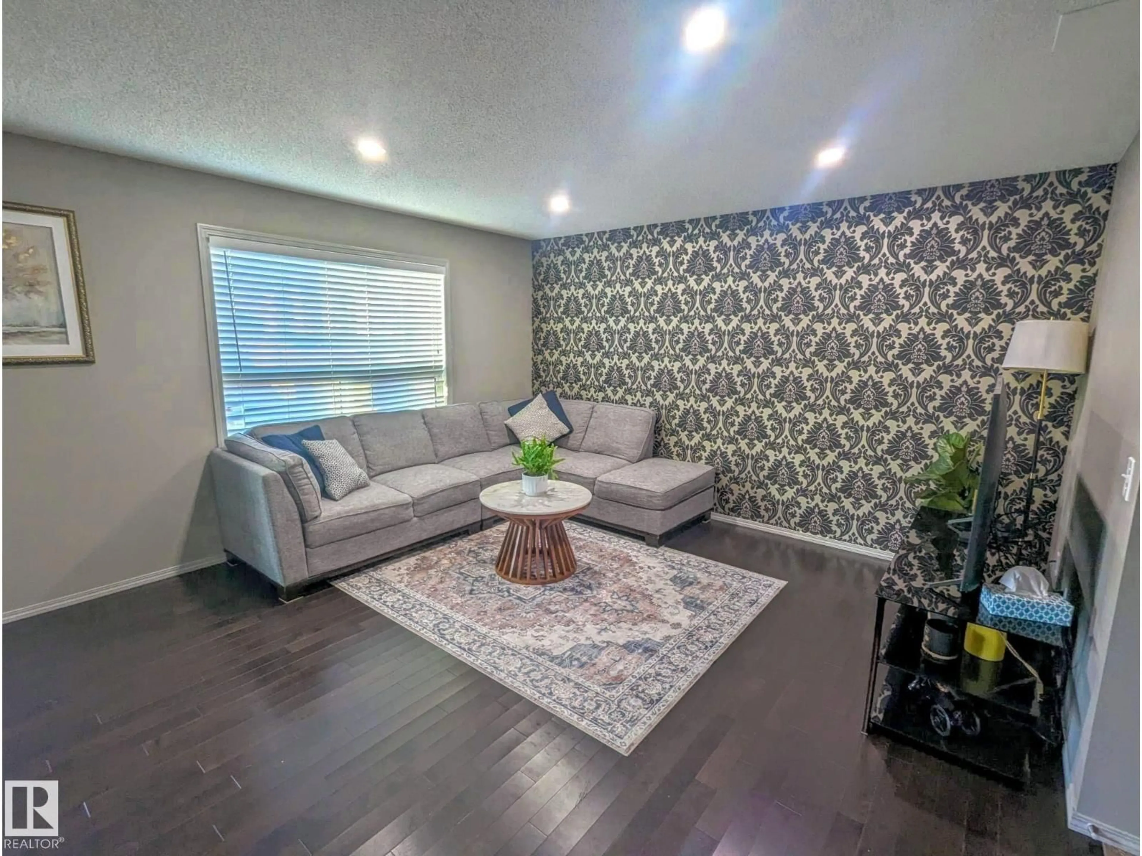 Living room with furniture, wood/laminate floor for NW - 3336 17B AV, Edmonton Alberta T6T0P3