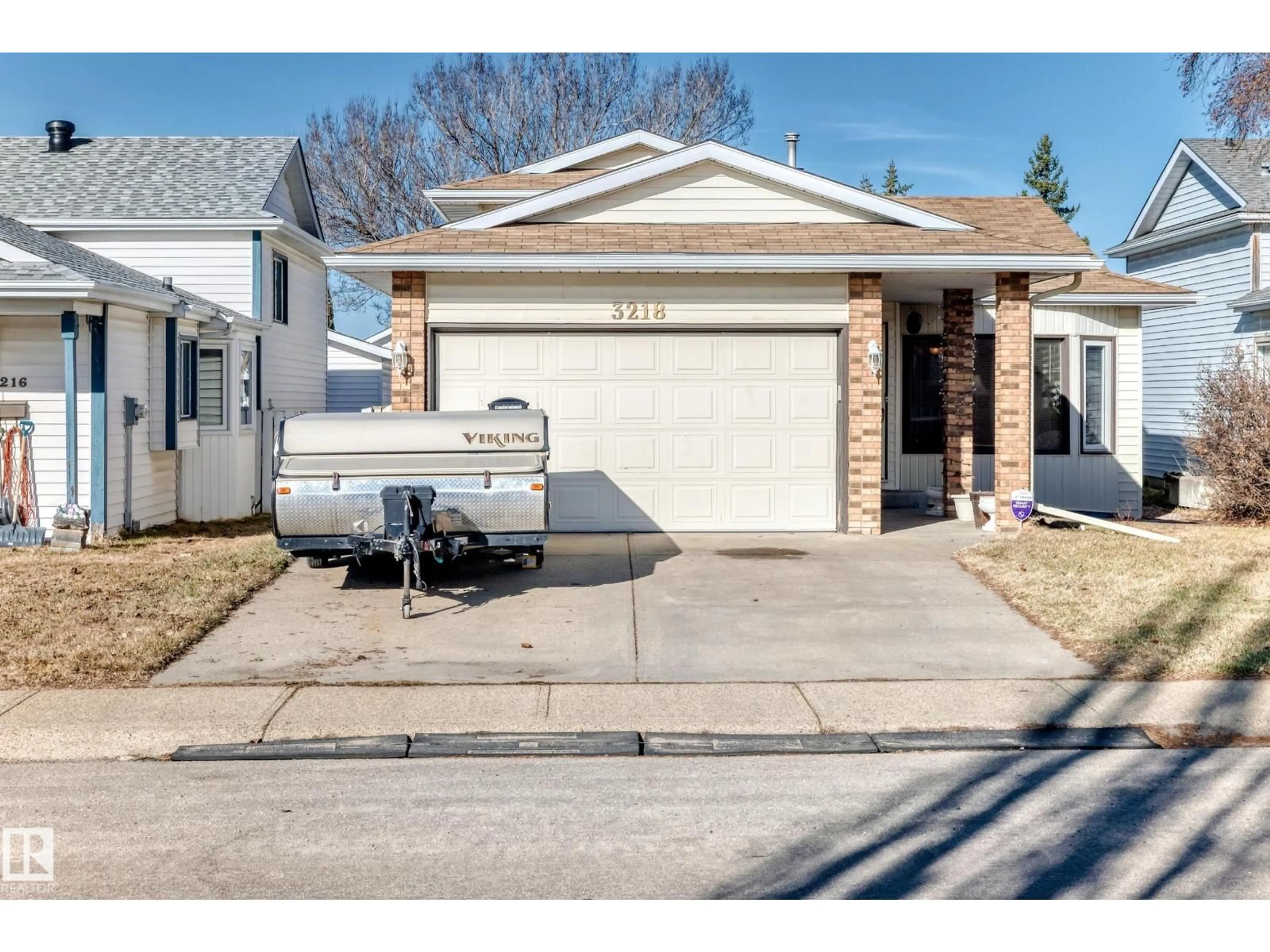 Home with vinyl exterior material, street for 3218 36 ST, Edmonton Alberta T6L4V9