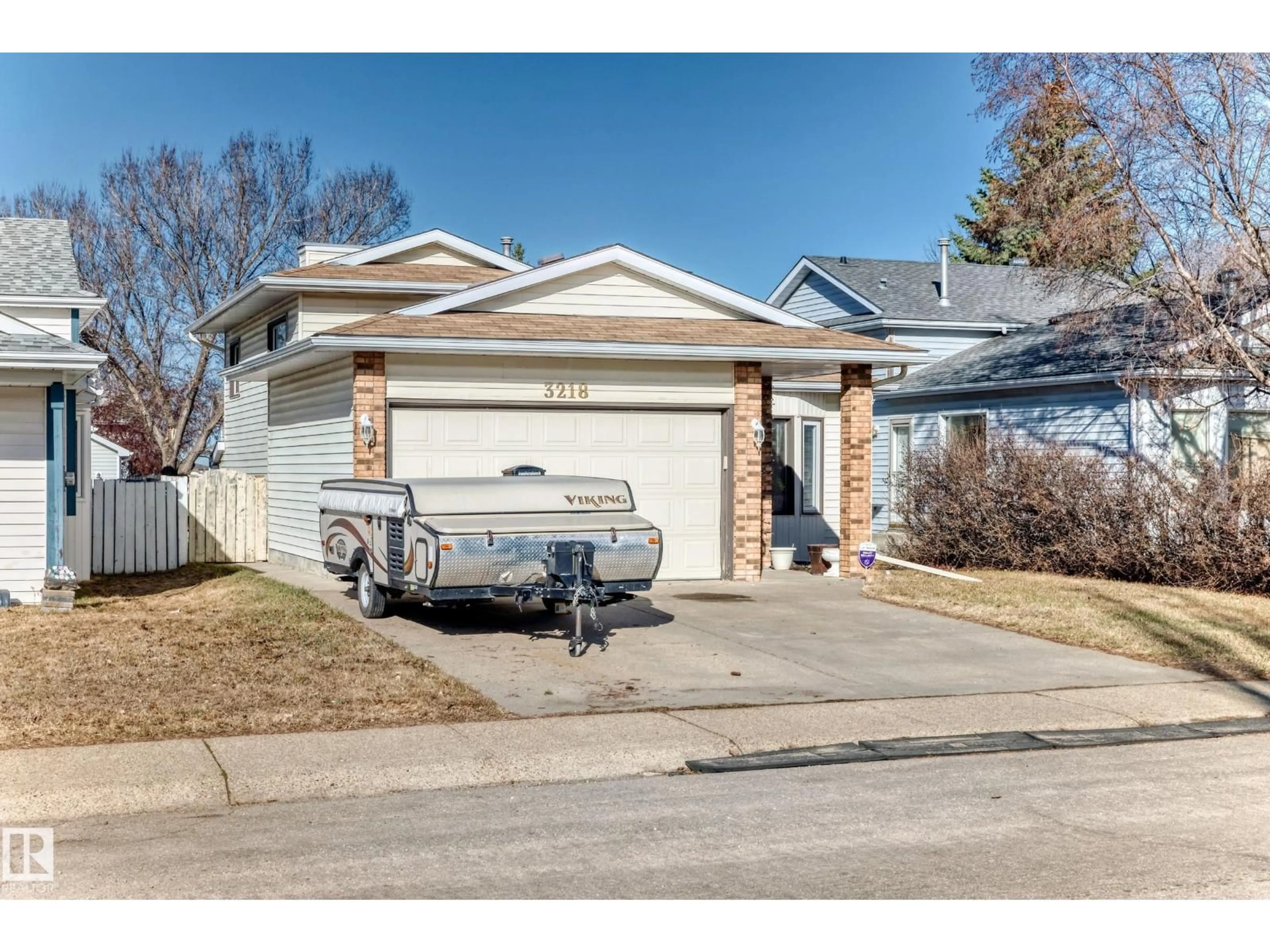 Home with vinyl exterior material, street for 3218 36 ST, Edmonton Alberta T6L4V9