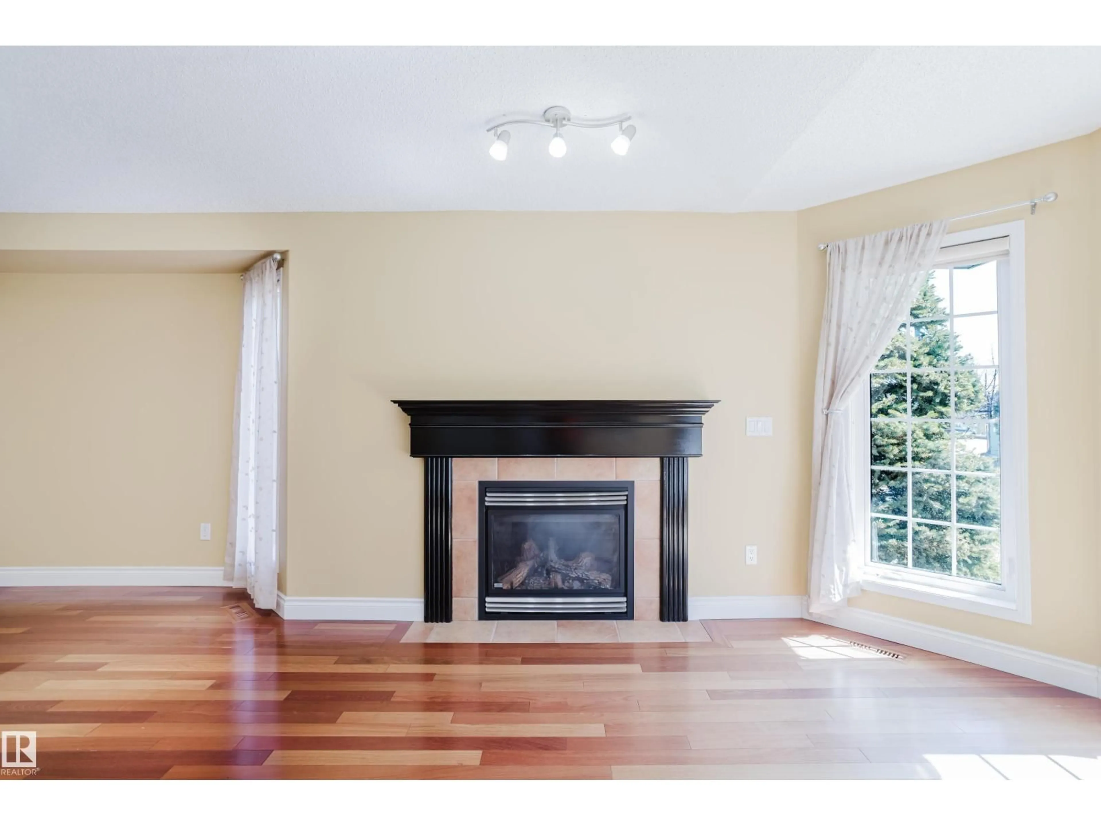 Living room with furniture, wood/laminate floor for 9 - 102 BRIDGEPORT CX, Leduc Alberta T9E8K8