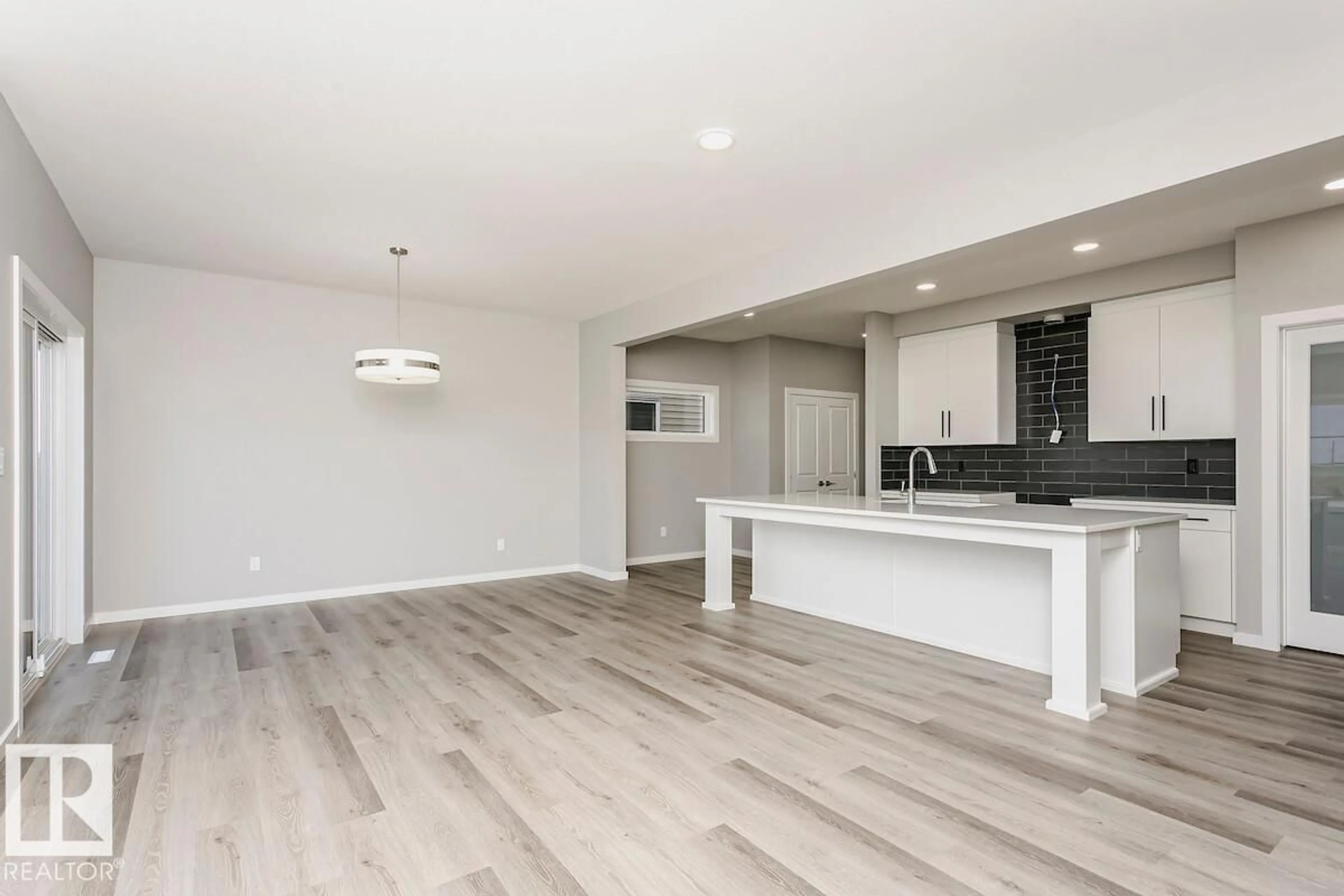 Open concept kitchen, wood/laminate floor for 50 GAMBEL LO, Spruce Grove Alberta T7X0C9