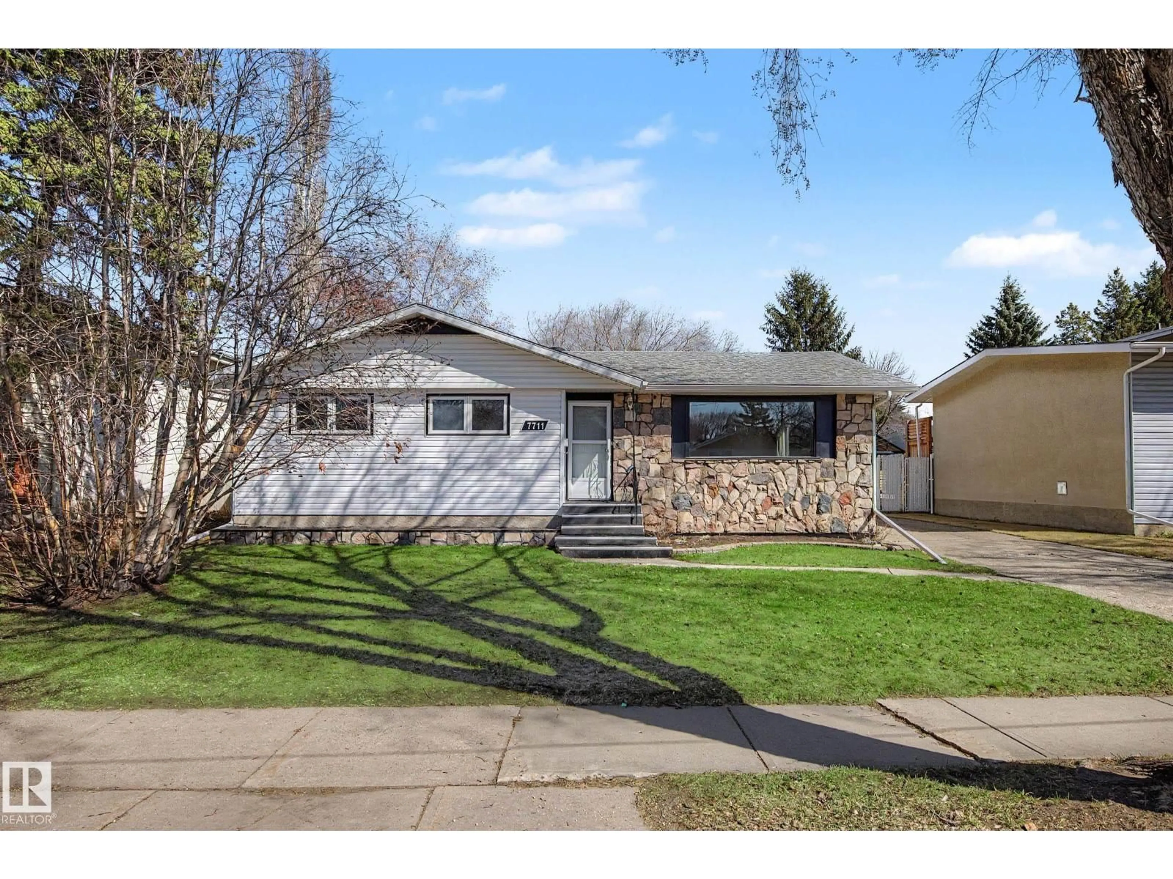 Home with vinyl exterior material, street for 7711 156 ST, Edmonton Alberta T5R1X6