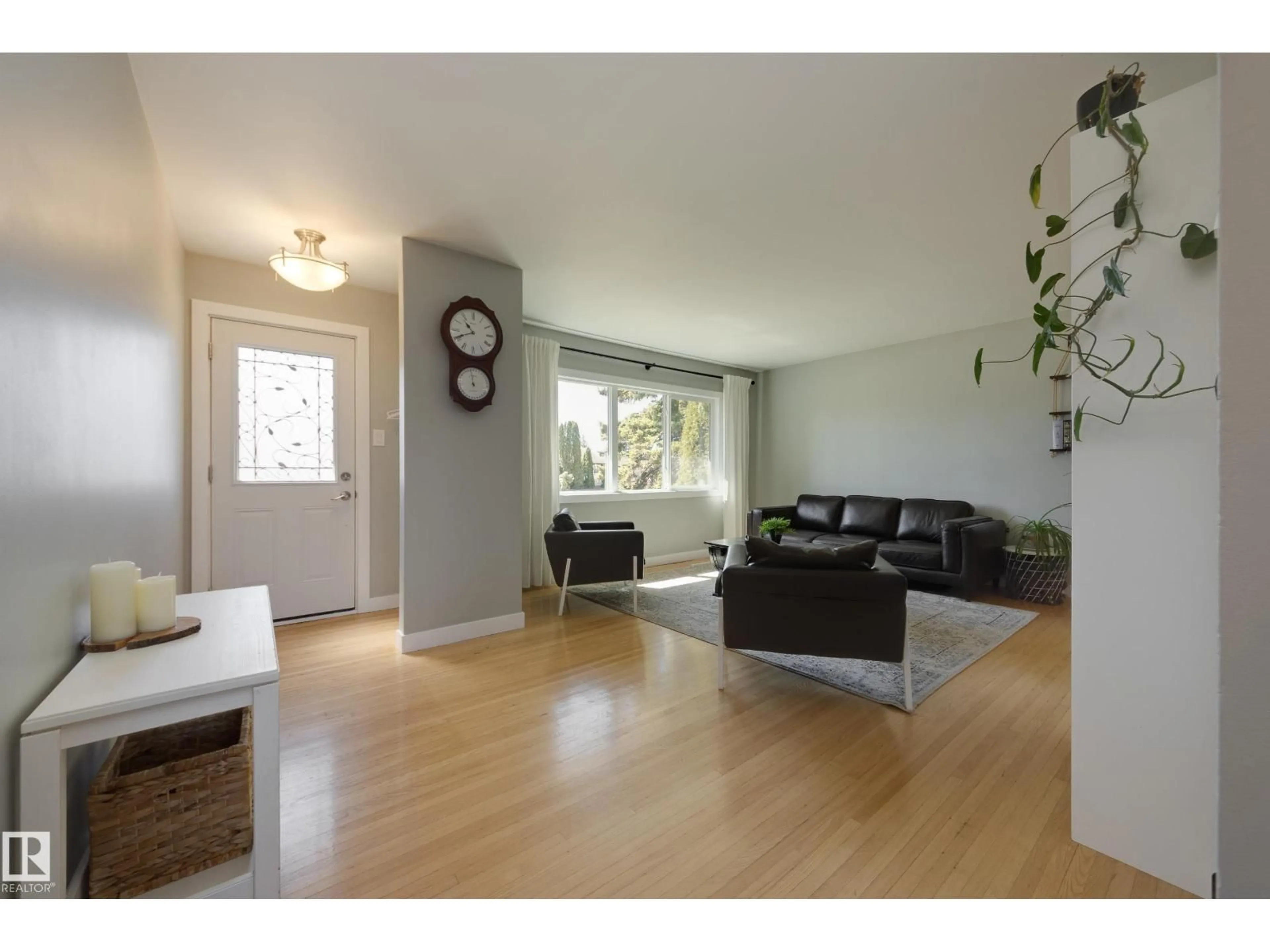 Living room with furniture, wood/laminate floor for 15972 110B AV, Edmonton Alberta T5P1J4