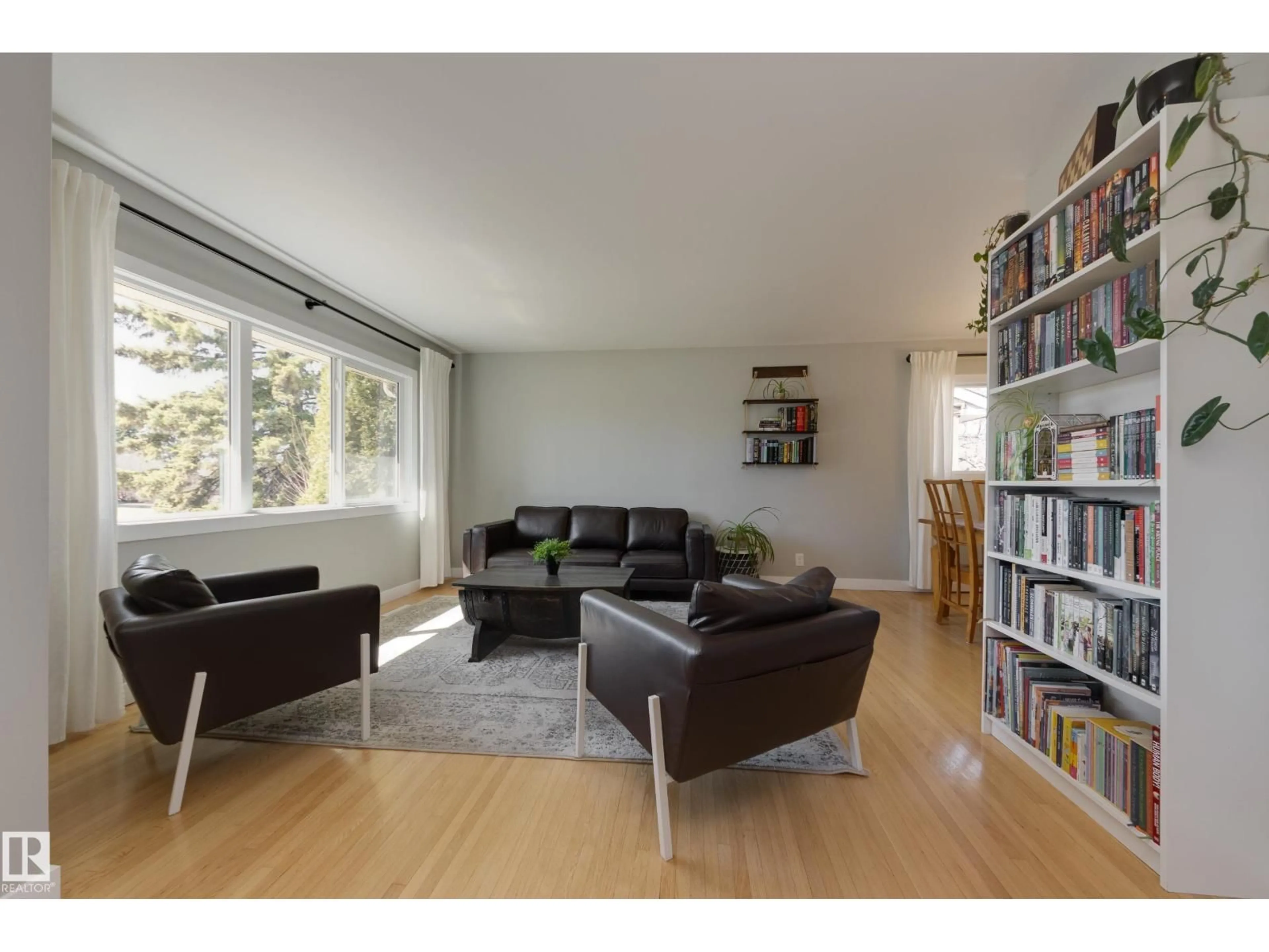 Living room with furniture, wood/laminate floor for 15972 110B AV, Edmonton Alberta T5P1J4