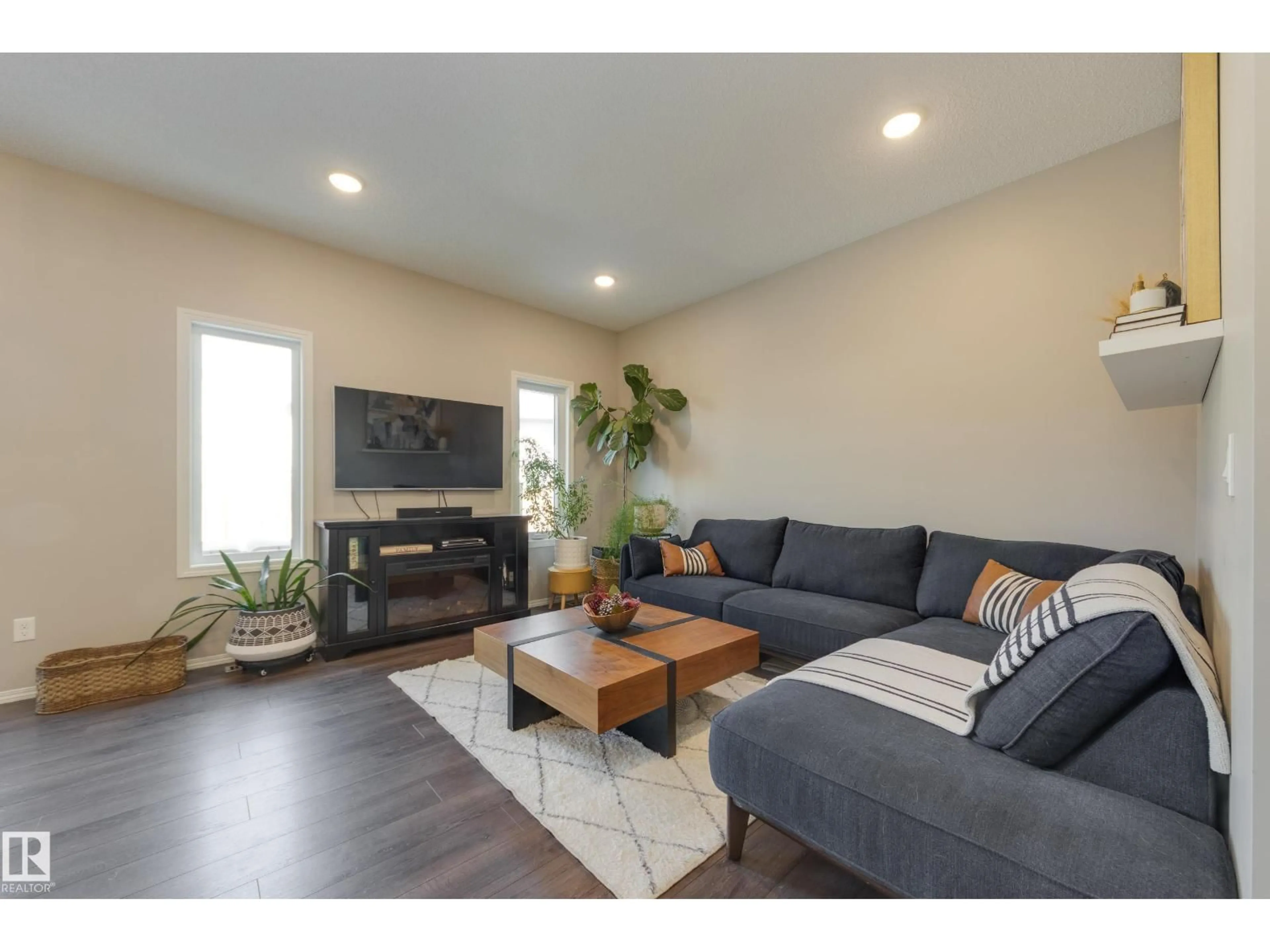 Living room with furniture, wood/laminate floor for NW - 12228 176 AV, Edmonton Alberta T5X0L2