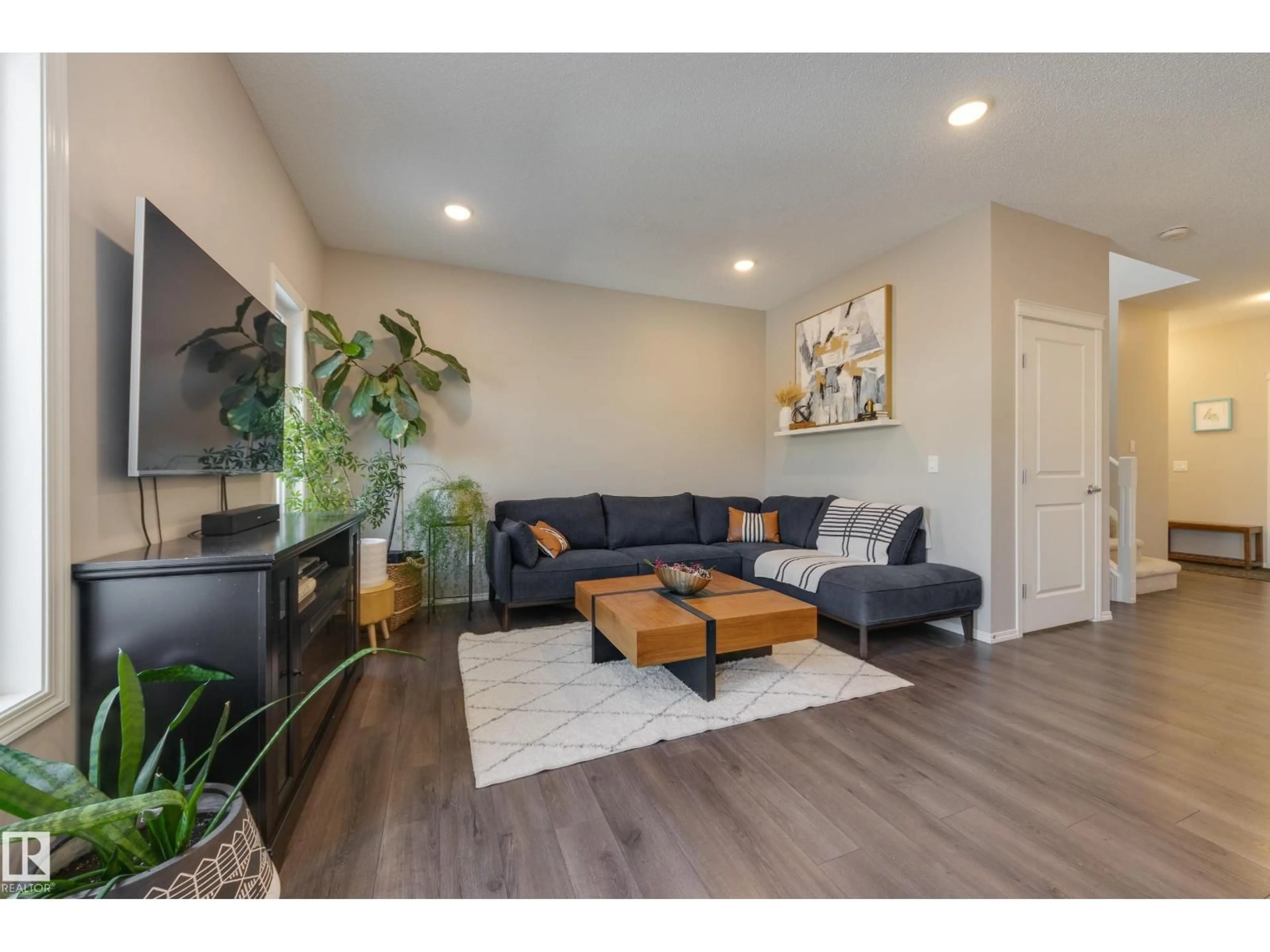 Living room with furniture, wood/laminate floor for NW - 12228 176 AV, Edmonton Alberta T5X0L2