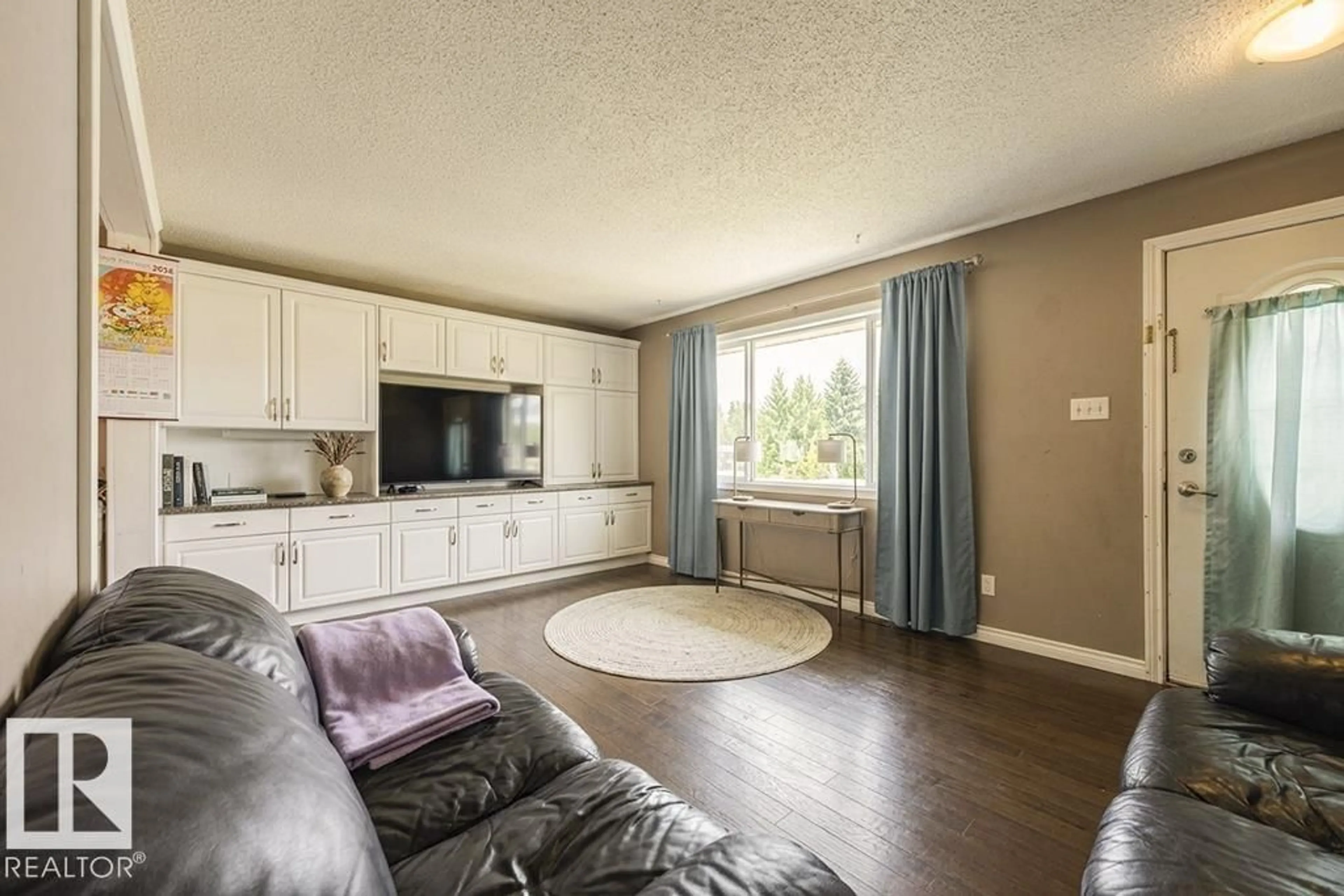 Living room with furniture, wood/laminate floor for NW - 9827 152 ST, Edmonton Alberta T5P1X2