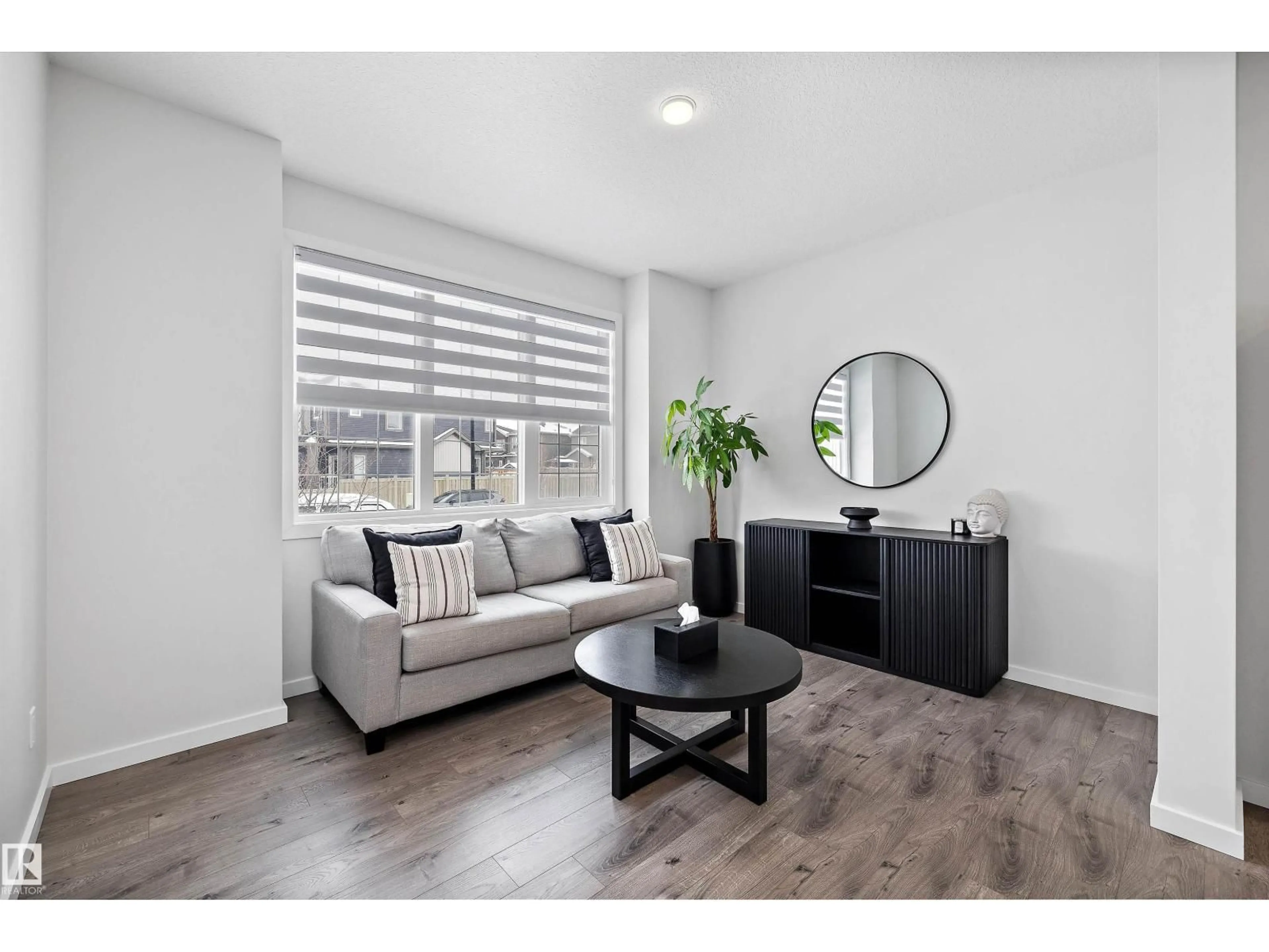 Living room with furniture, wood/laminate floor for 22539 81 AV, Edmonton Alberta T5T7K9