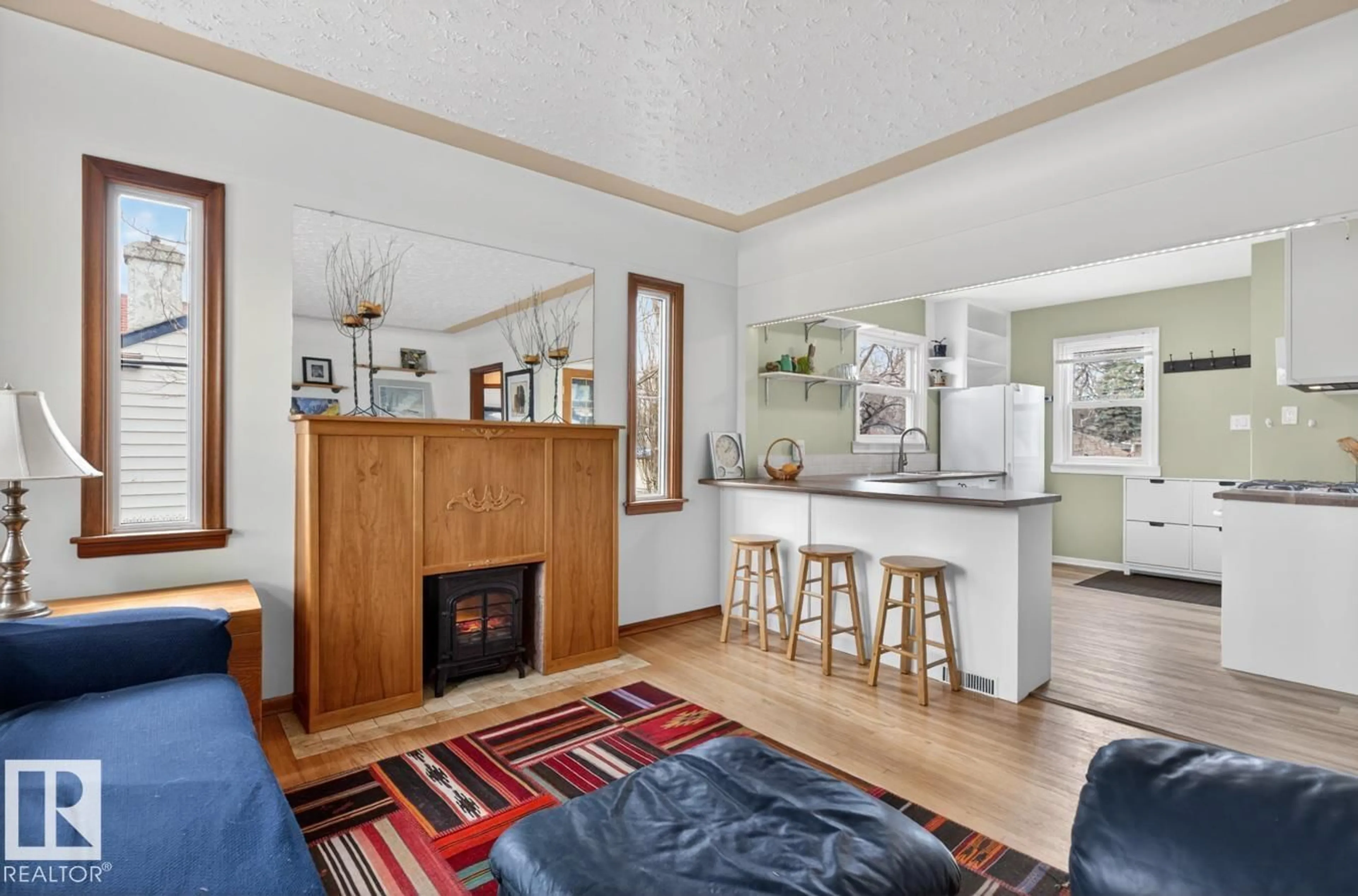 Living room with furniture, wood/laminate floor for NW - 12130 60 ST, Edmonton Alberta T5W2E9