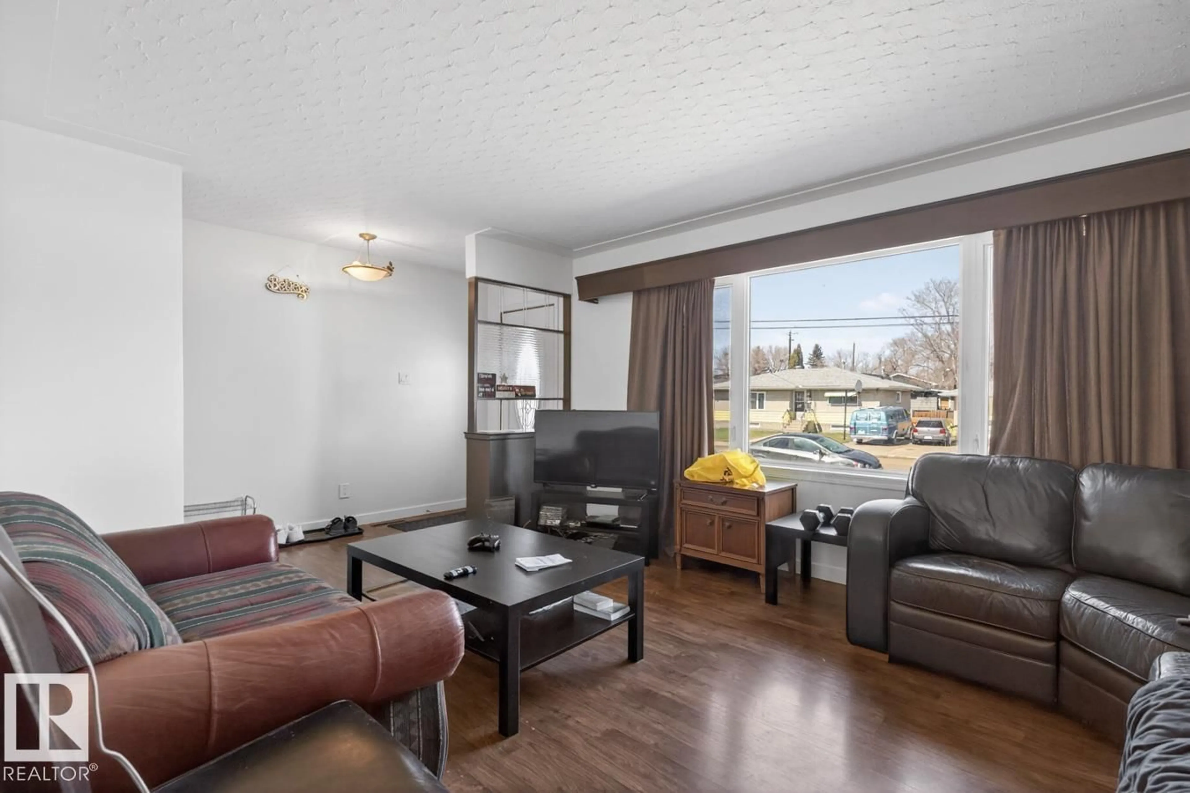 Living room with furniture, wood/laminate floor for 4641 116 AV, Edmonton Alberta T5W0X5