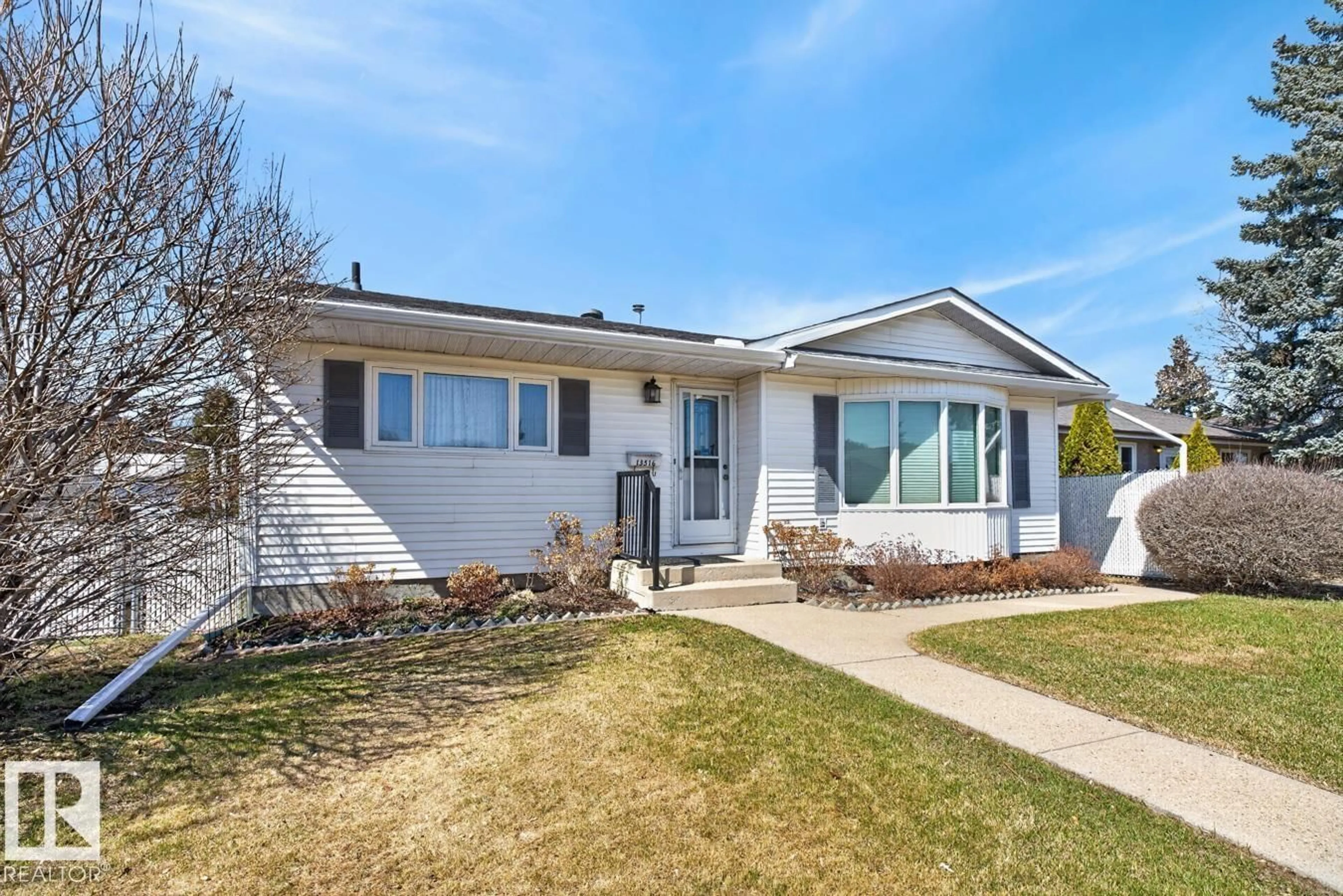 Home with vinyl exterior material, street for 13516 120 ST, Edmonton Alberta T5E5P7