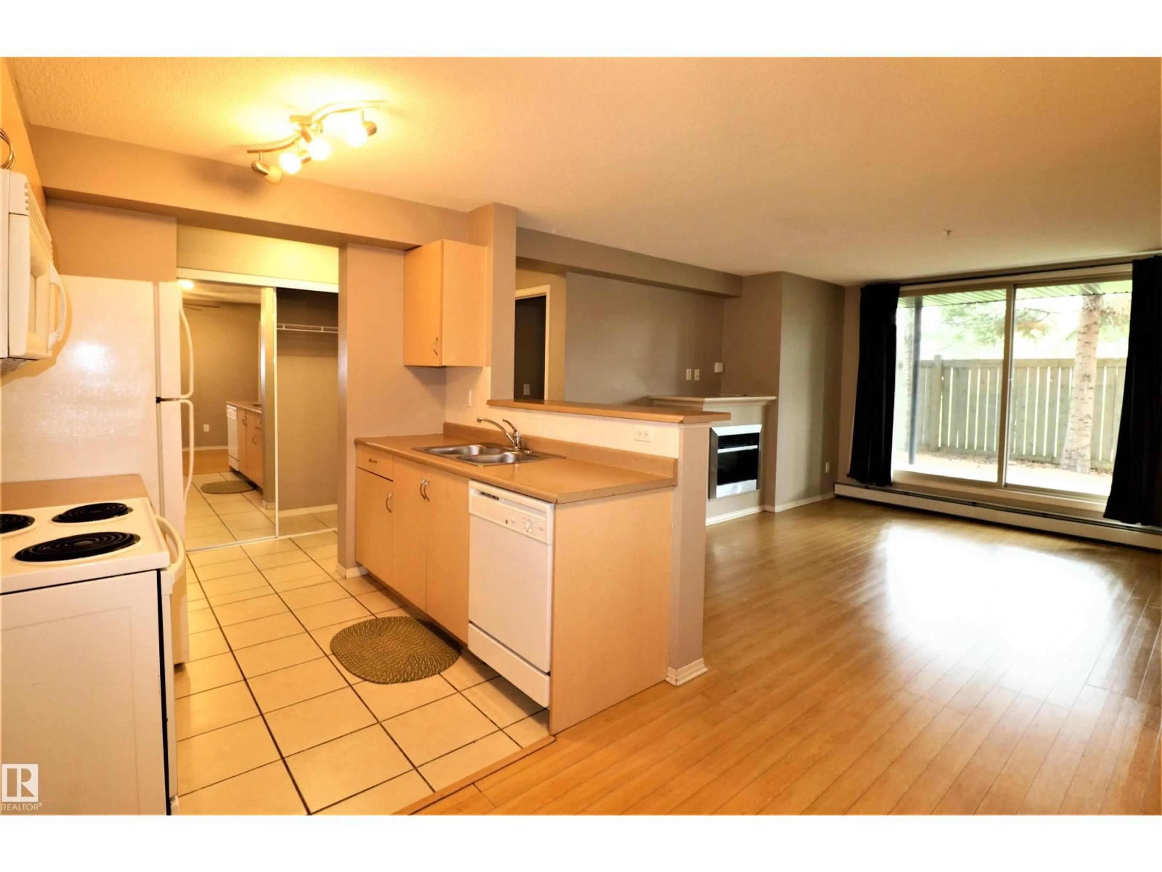 Open concept kitchen, wood/laminate floor for 117 17003 67 AV NW, Edmonton Alberta T5T6Y5