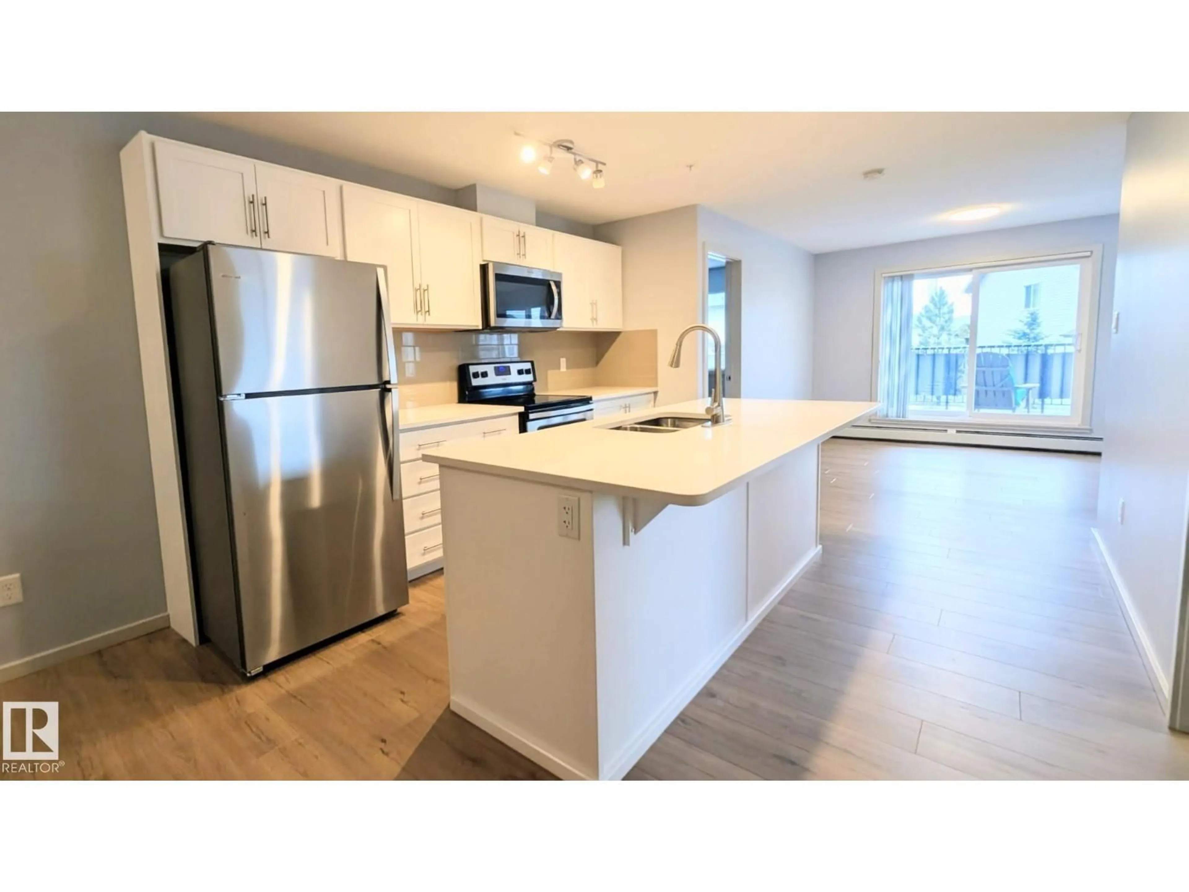 Open concept kitchen, wood/laminate floor for 120 - 5404 7 AV, Edmonton Alberta T6X2X4