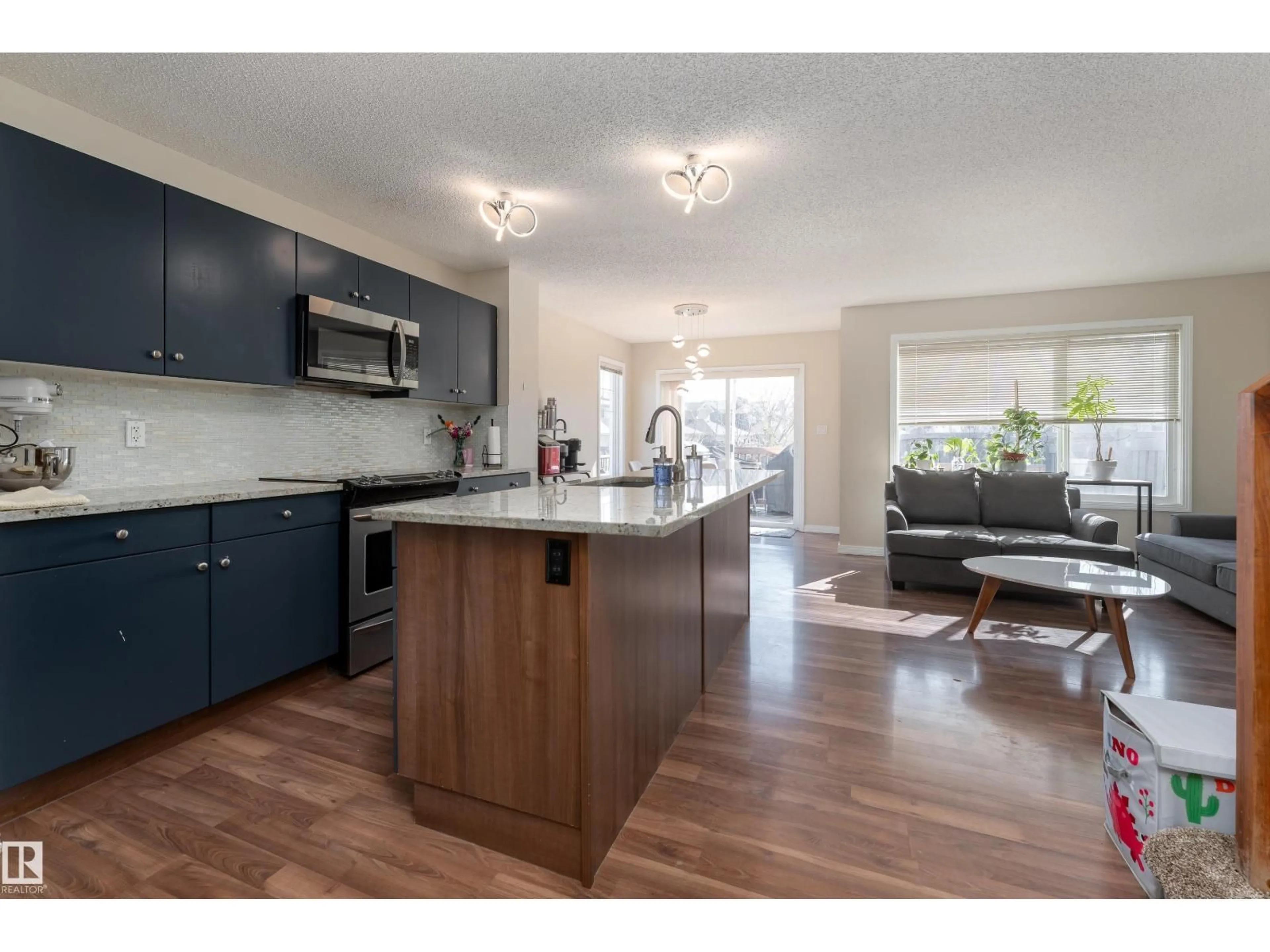 Open concept kitchen, wood/laminate floor for SW - 1019 177 ST, Edmonton Alberta T6W1Z9