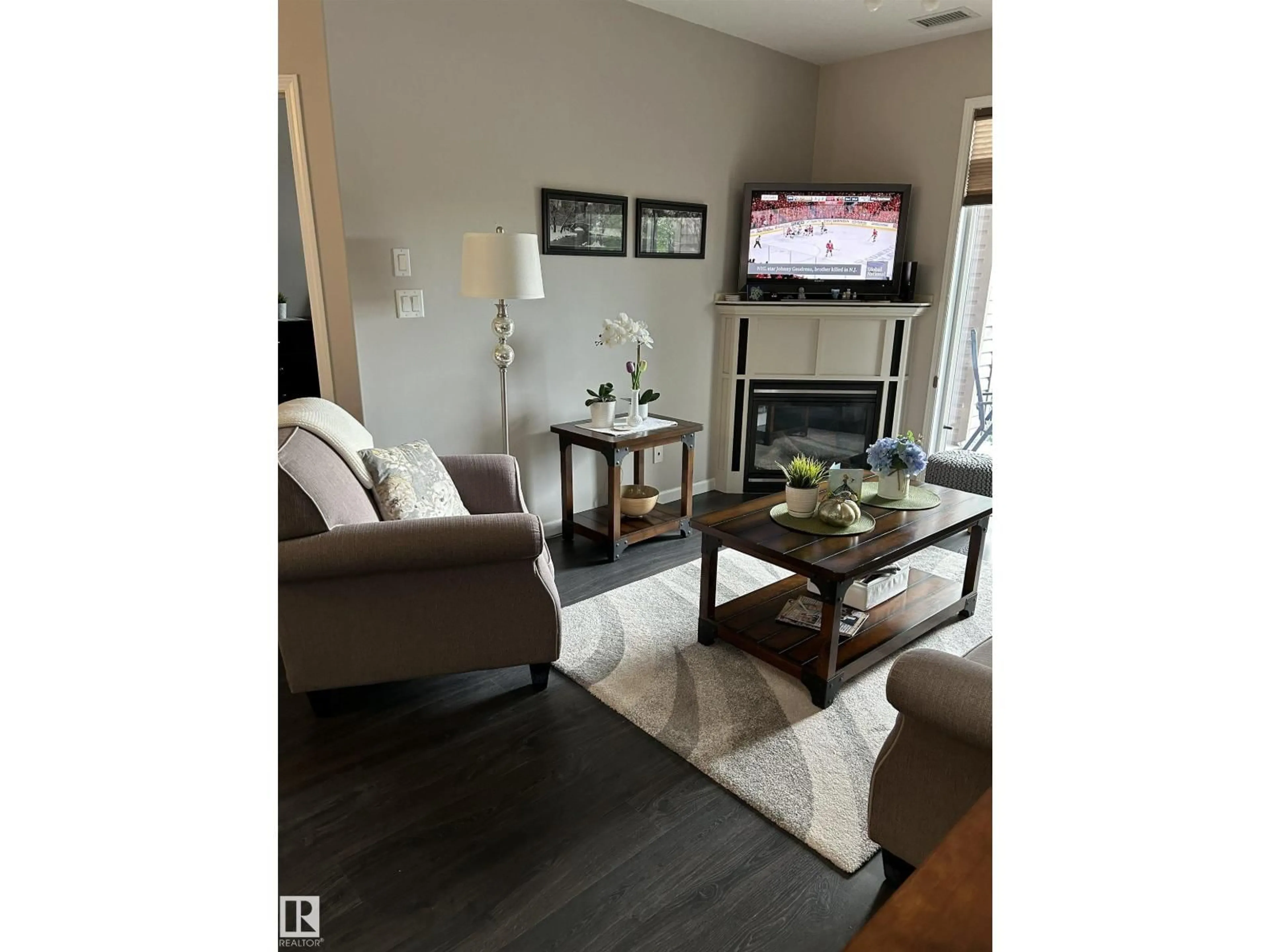 Living room with furniture, wood/laminate floor for #226 - 2503 HANNA CR, Edmonton Alberta T6R0H1