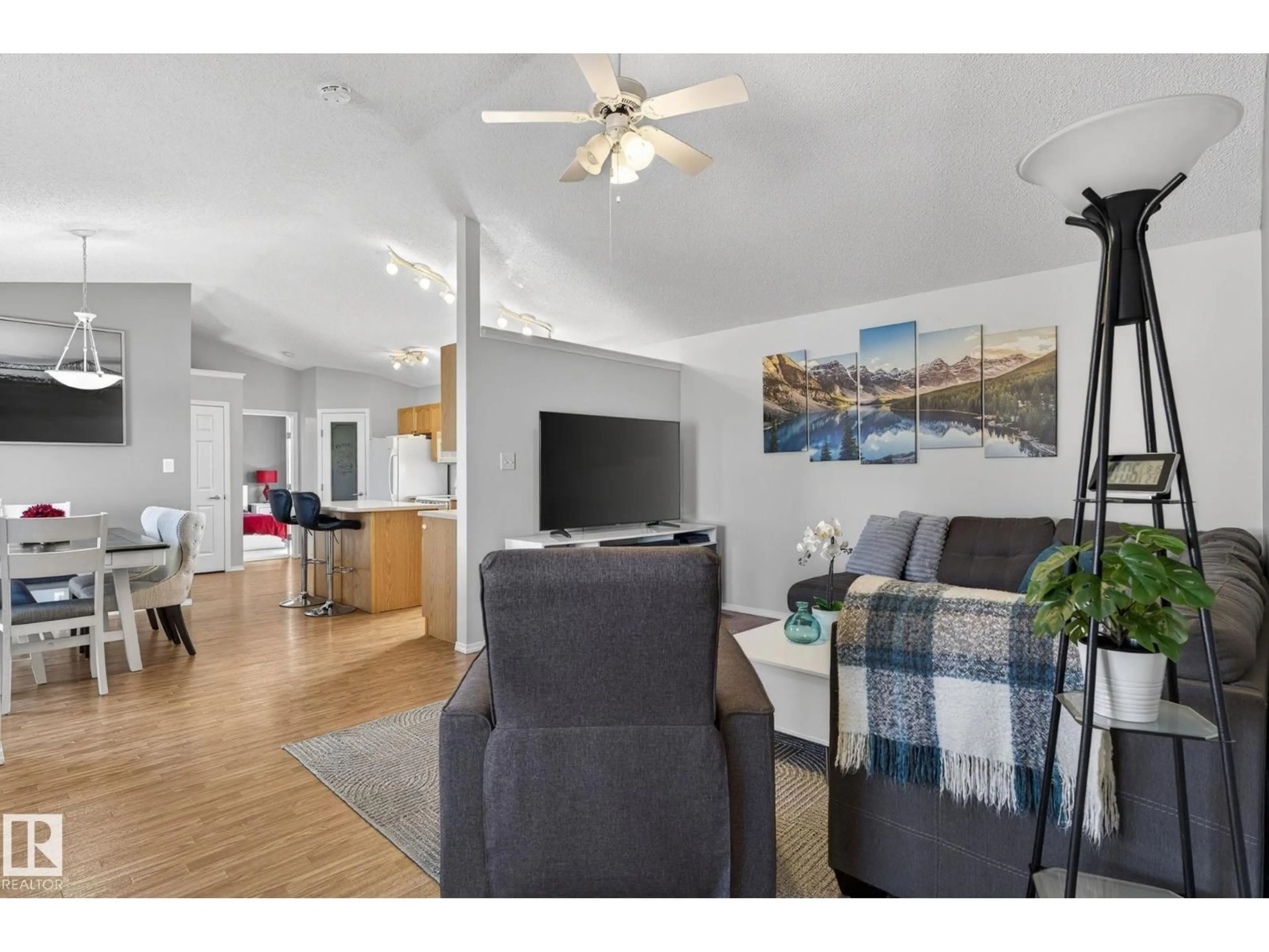Living room with furniture, wood/laminate floor for 26500 - 321A HWY 44, Rural Sturgeon County Alberta T0G1Y0
