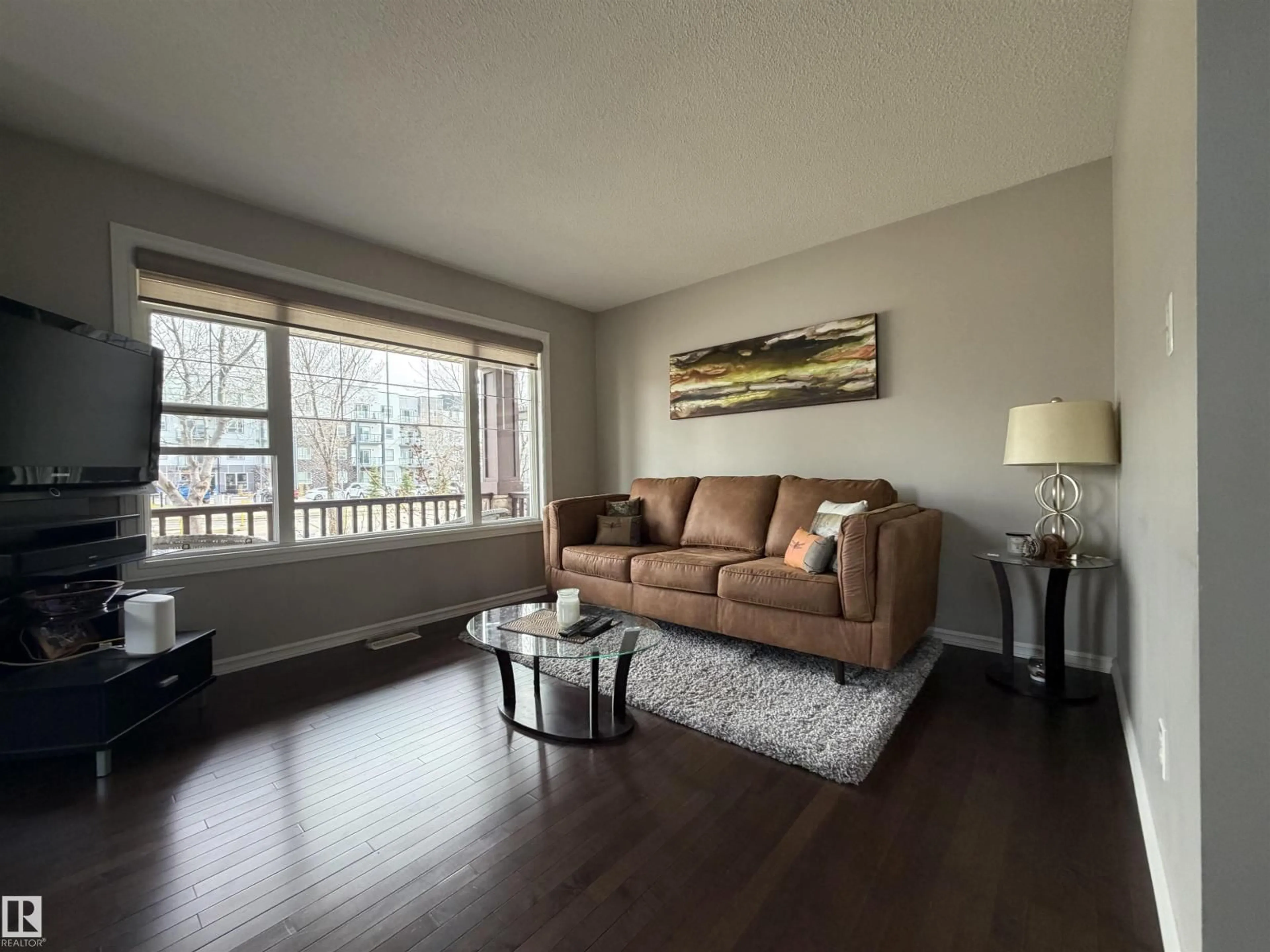Living room with furniture, wood/laminate floor for 5204 4 AV, Edmonton Alberta T6X0R2