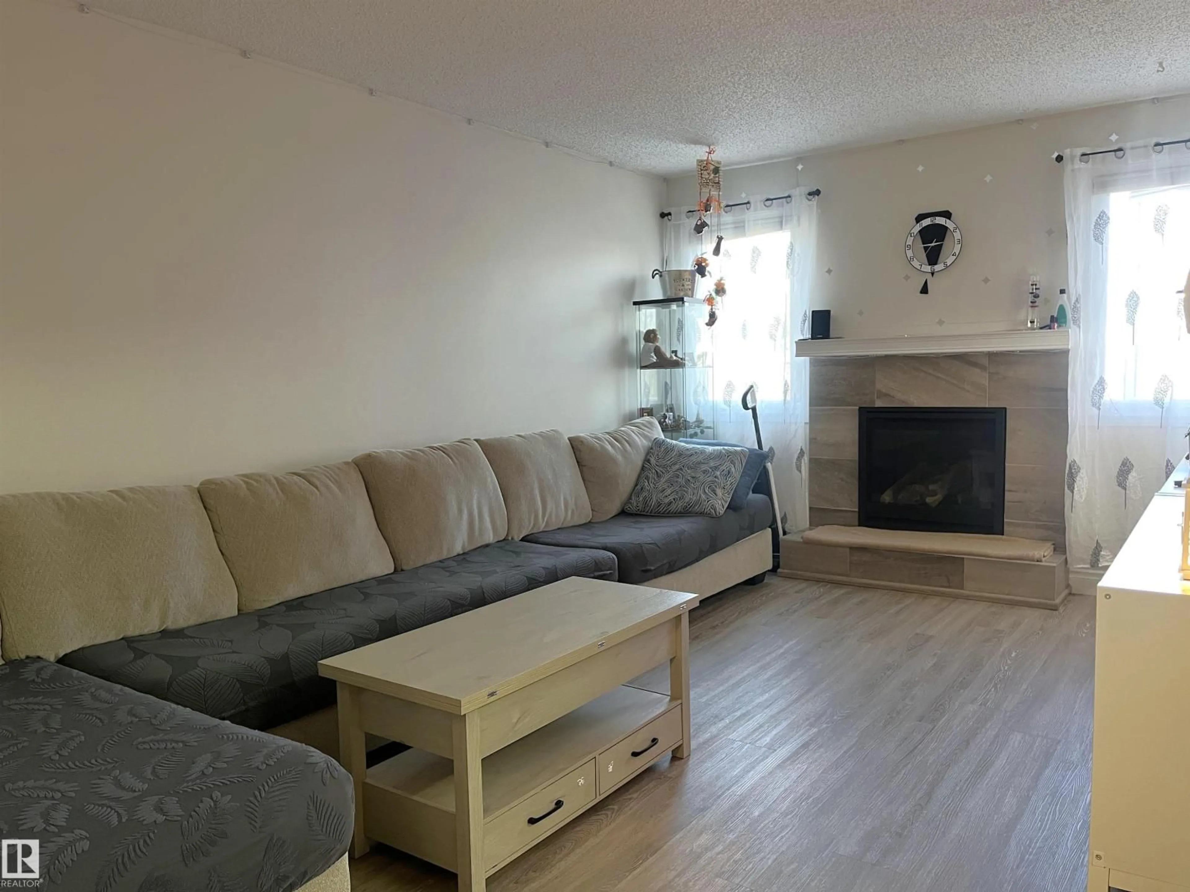 Living room with furniture, wood/laminate floor for 18160 96 AV, Edmonton Alberta T5T3N3