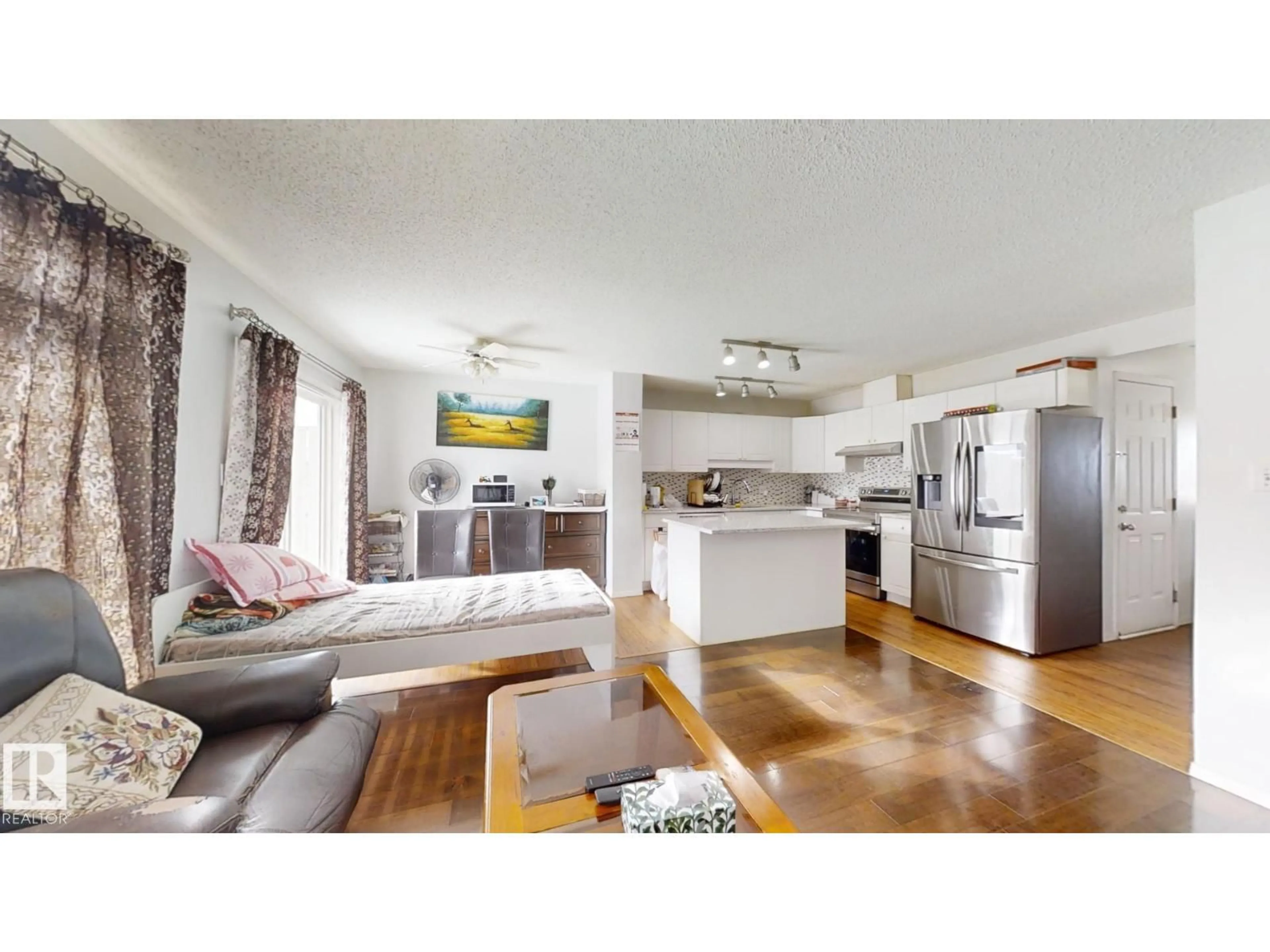 Open concept kitchen, wood/laminate floor for 3023 31 AV, Edmonton Alberta T6T1W9