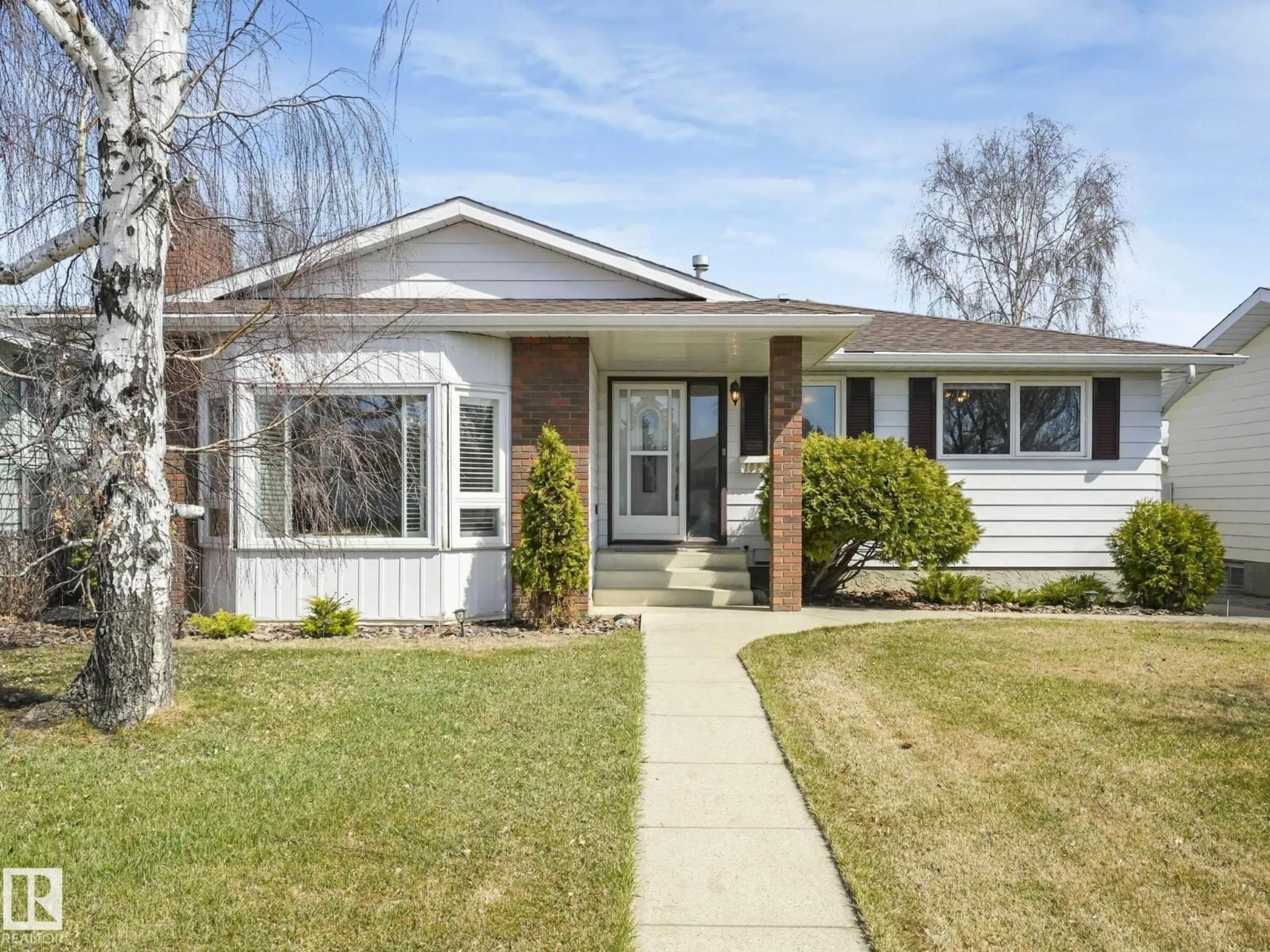 Home with vinyl exterior material, street for 1027 77 ST, Edmonton Alberta T6K3G4