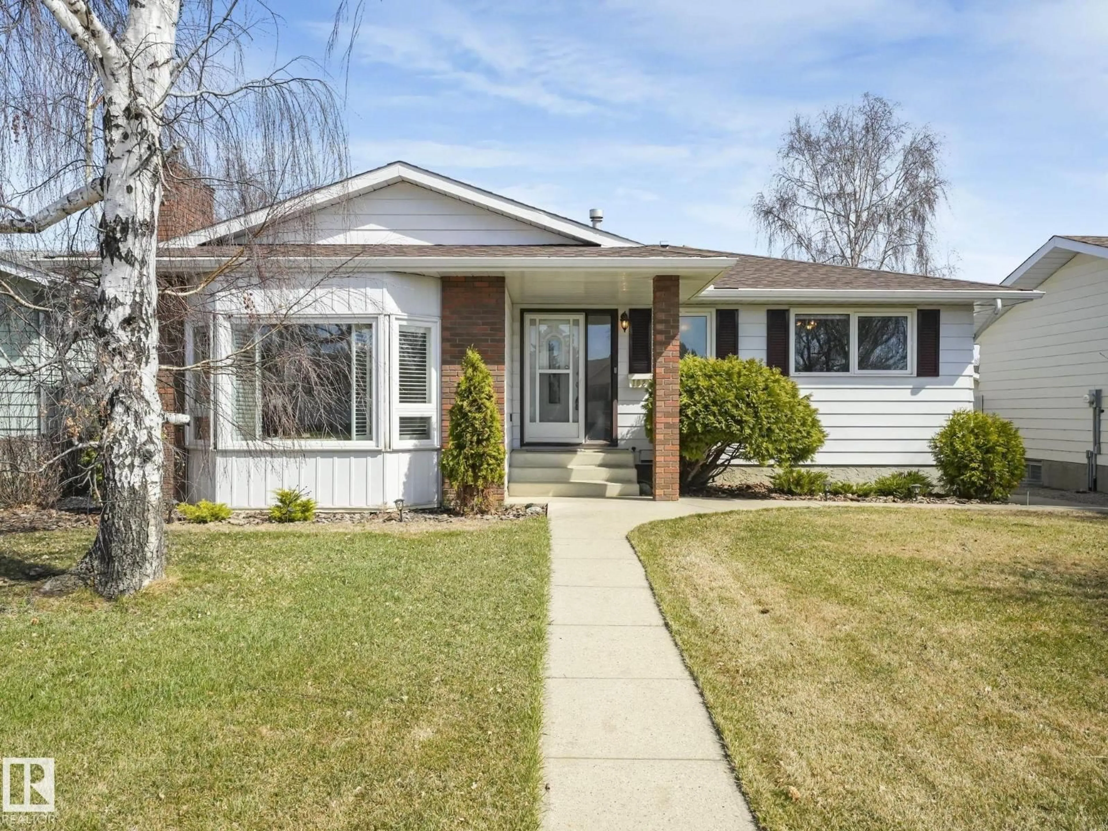 Home with vinyl exterior material, street for 1027 77 ST, Edmonton Alberta T6K3G4