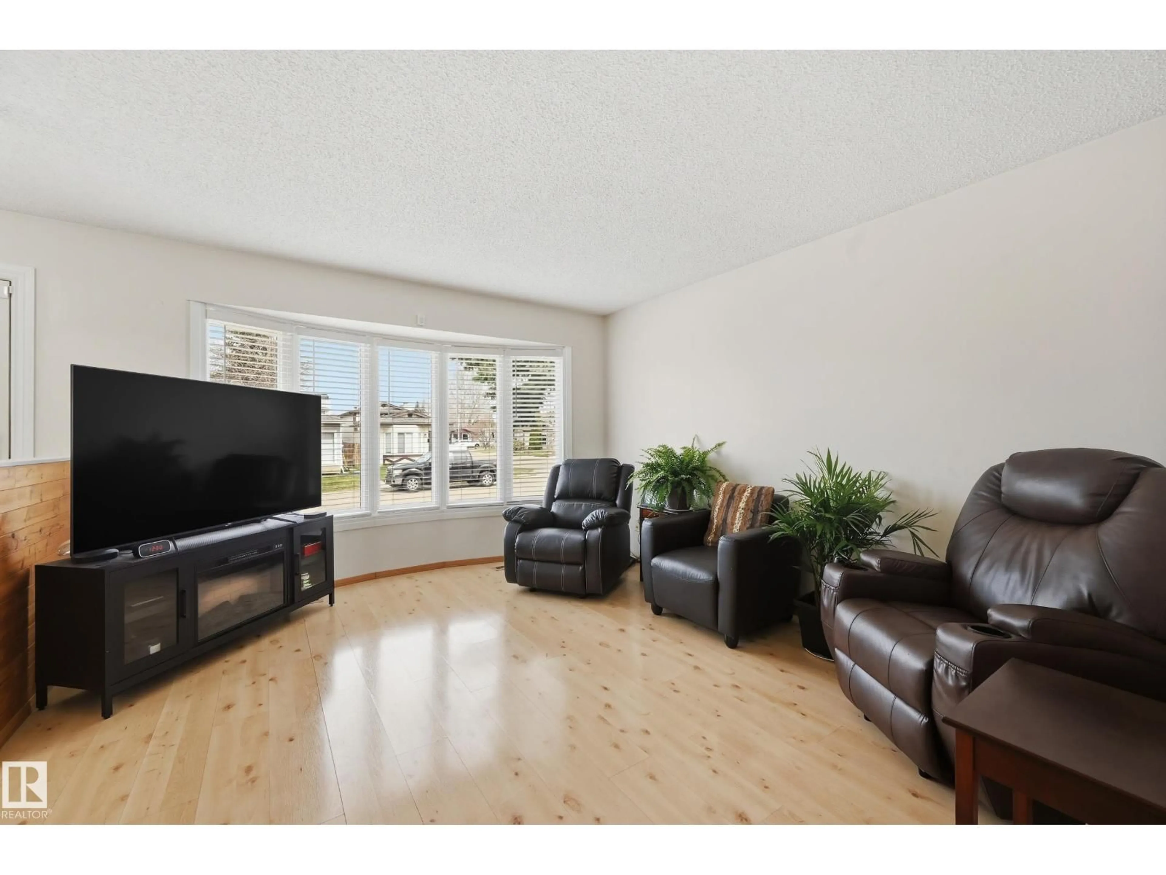 Living room with furniture, wood/laminate floor for 8305 157 AV, Edmonton Alberta T5Z2P8