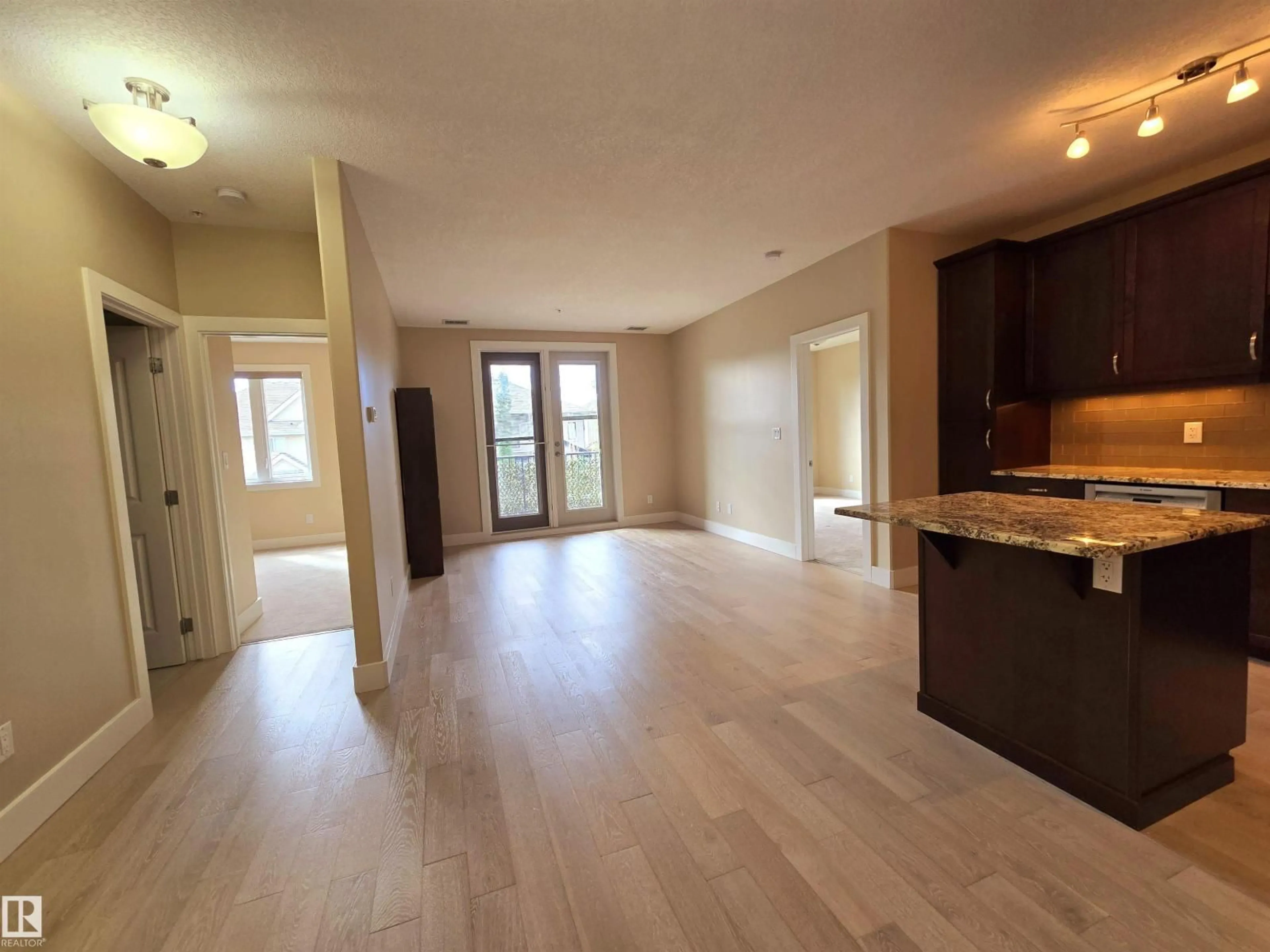 Open concept kitchen, wood/laminate floor for 6079 - 256 MAYNARD WY, Edmonton Alberta T6R0S4