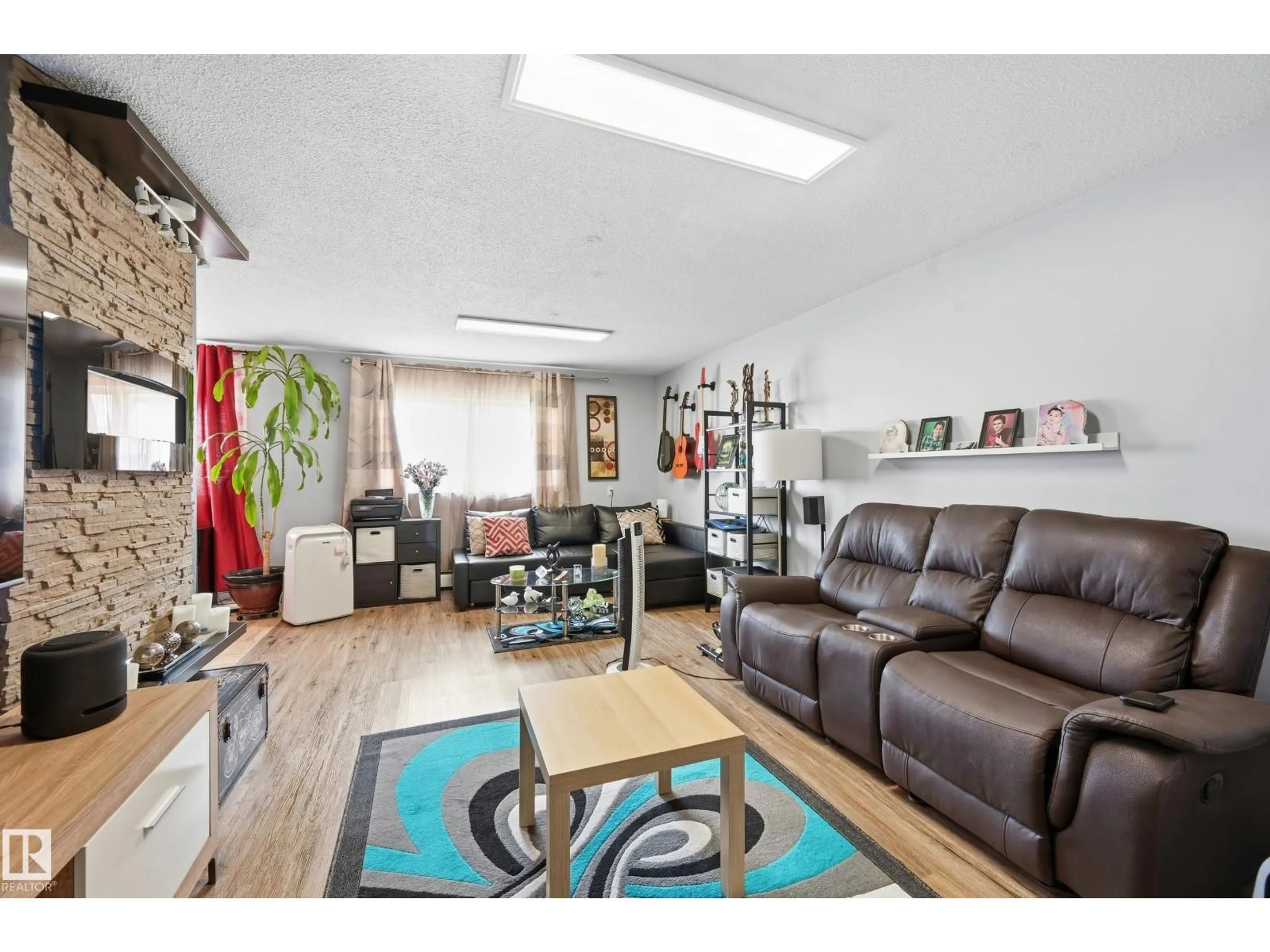 Living room with furniture, wood/laminate floor for 105 - 7204 81 AV, Edmonton Alberta T6B0E2