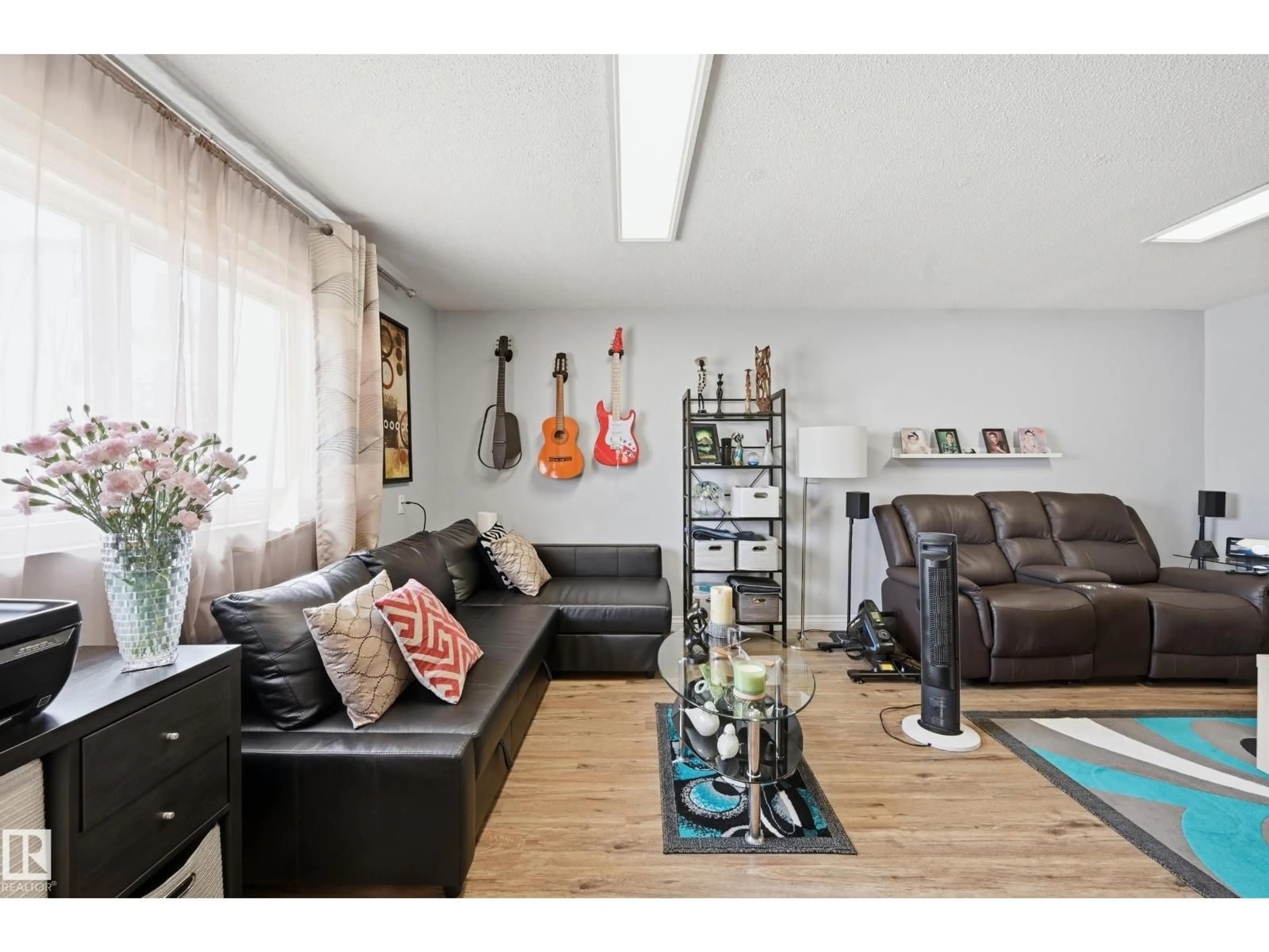 Living room with furniture, wood/laminate floor for 105 - 7204 81 AV, Edmonton Alberta T6B0E2