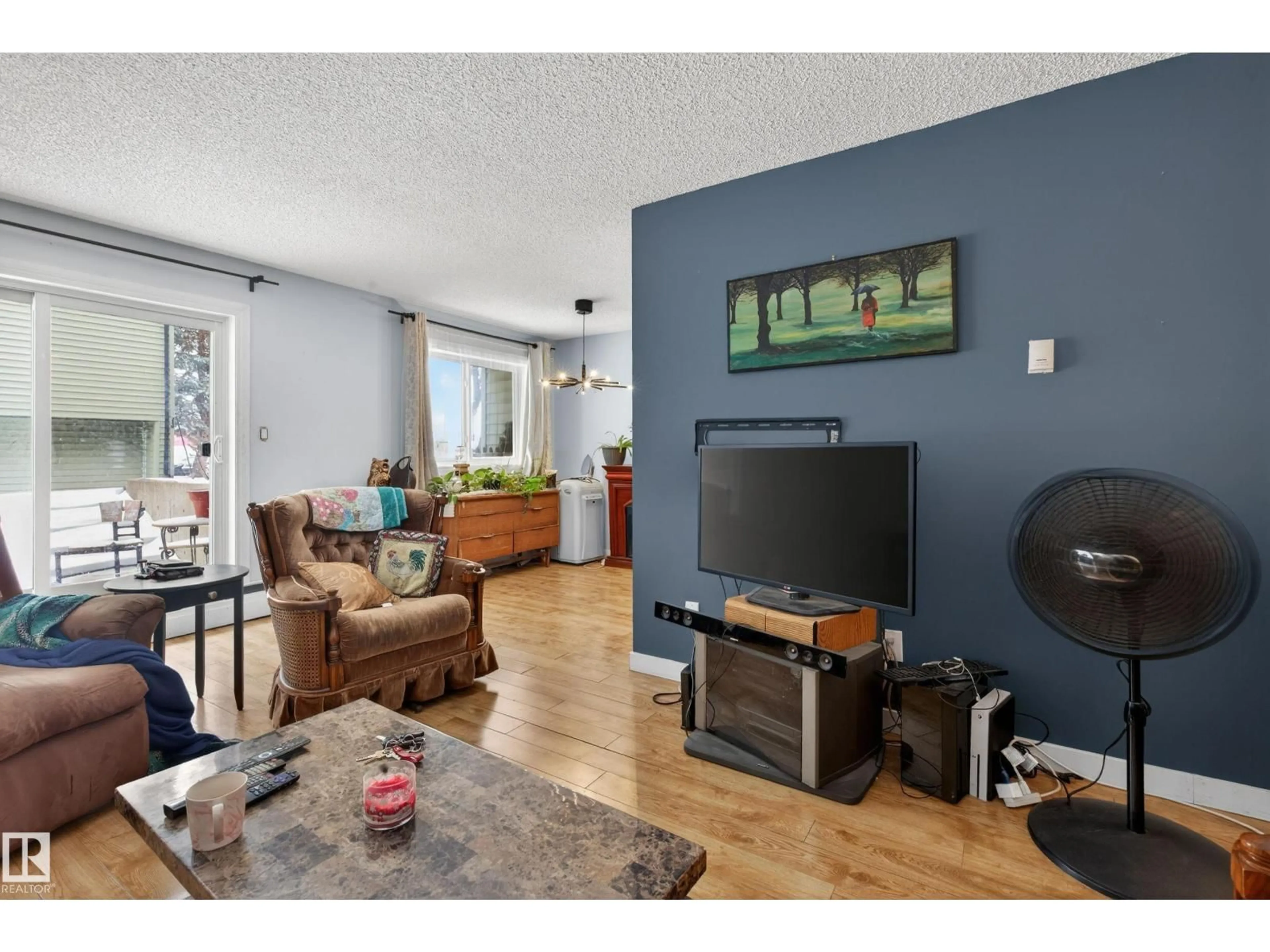Living room with furniture, wood/laminate floor for 13454 FORT RD NW, Edmonton Alberta T5A1C5