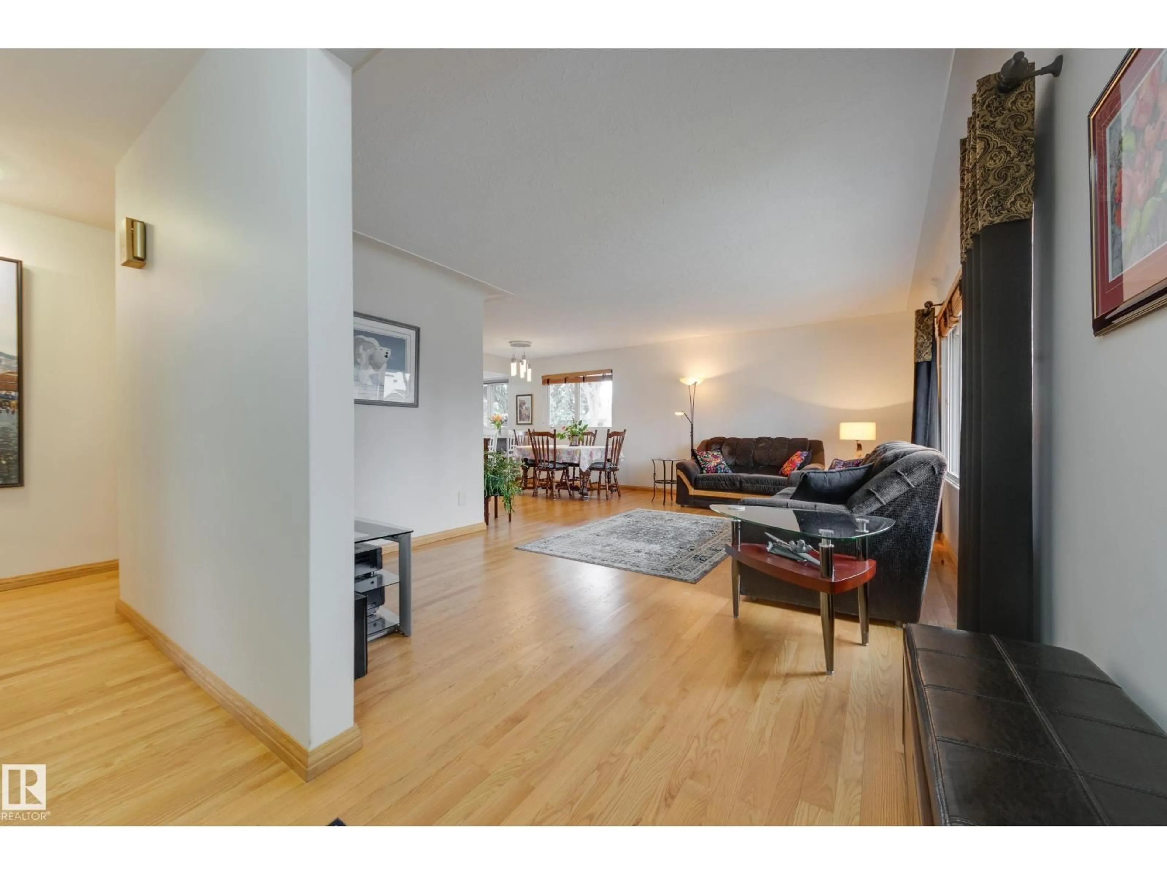 Living room with furniture, wood/laminate floor for 9503 77 ST, Edmonton Alberta T6C2M8
