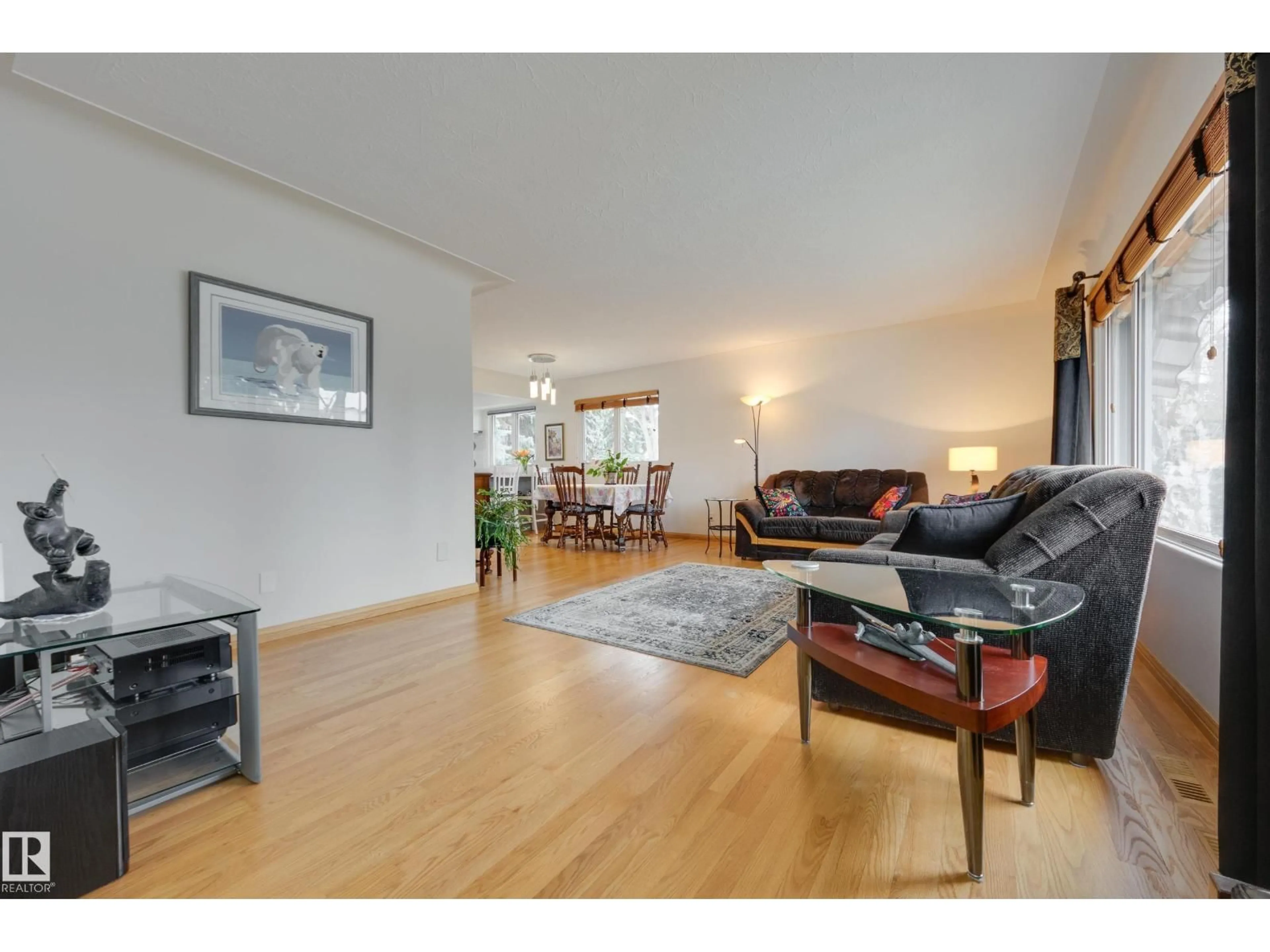 Living room with furniture, wood/laminate floor for 9503 77 ST, Edmonton Alberta T6C2M8