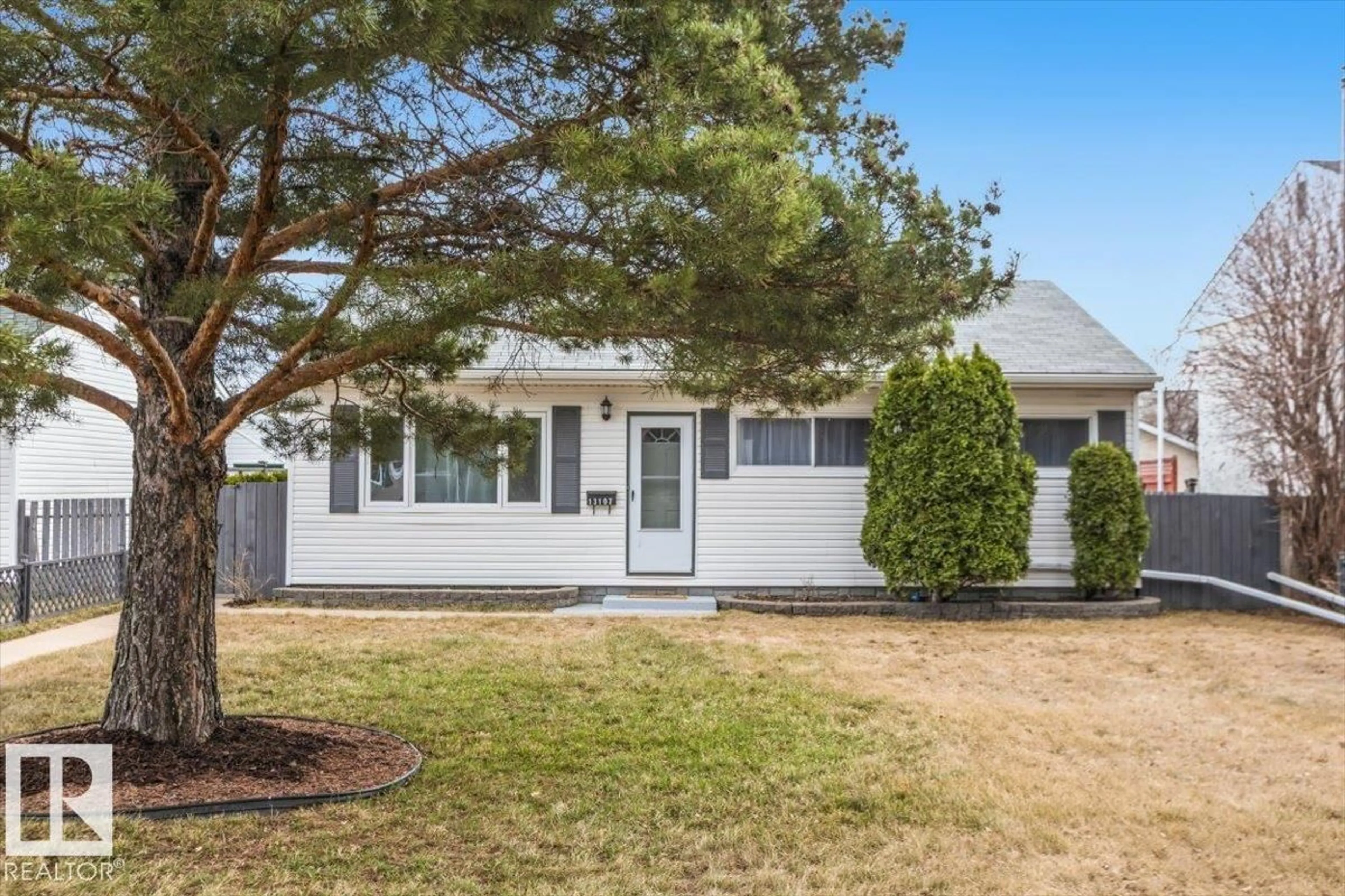 Home with vinyl exterior material, street for 13107 133 ST, Edmonton Alberta T5L1T2