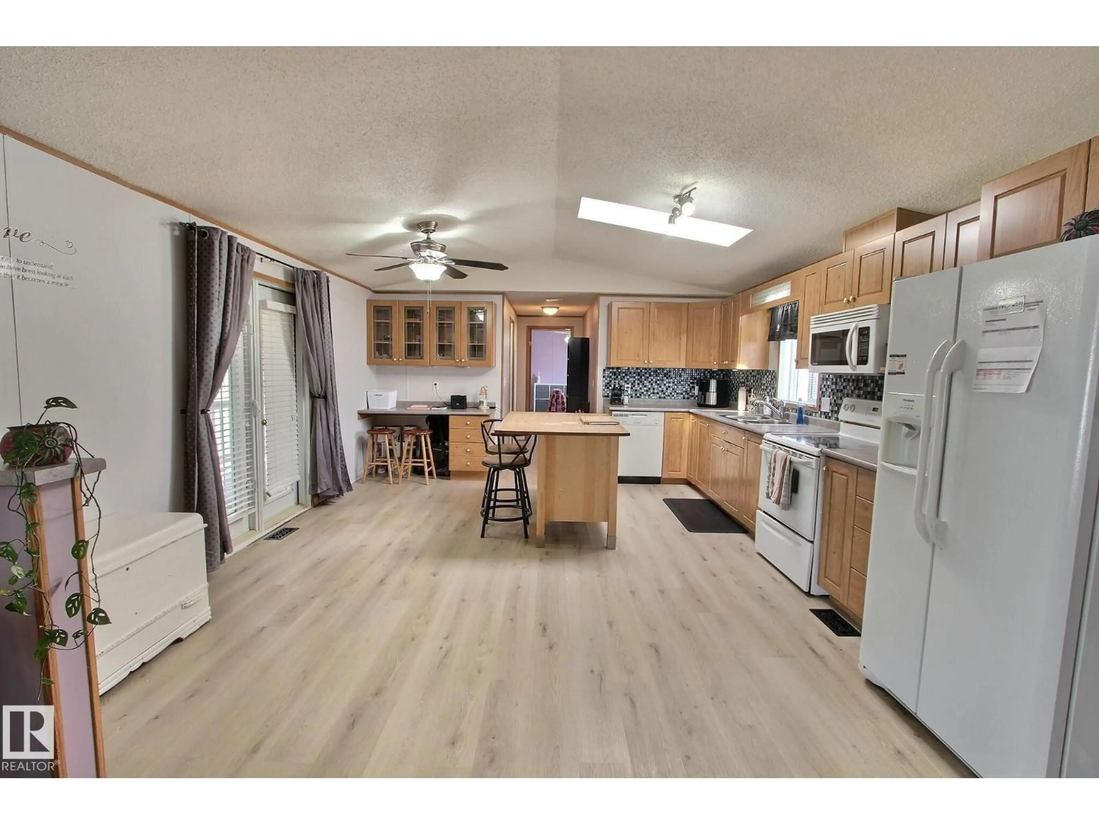 Open concept kitchen, wood/laminate floor for 446 - 53222 RR 272, Rural Parkland County Alberta T7X3P6