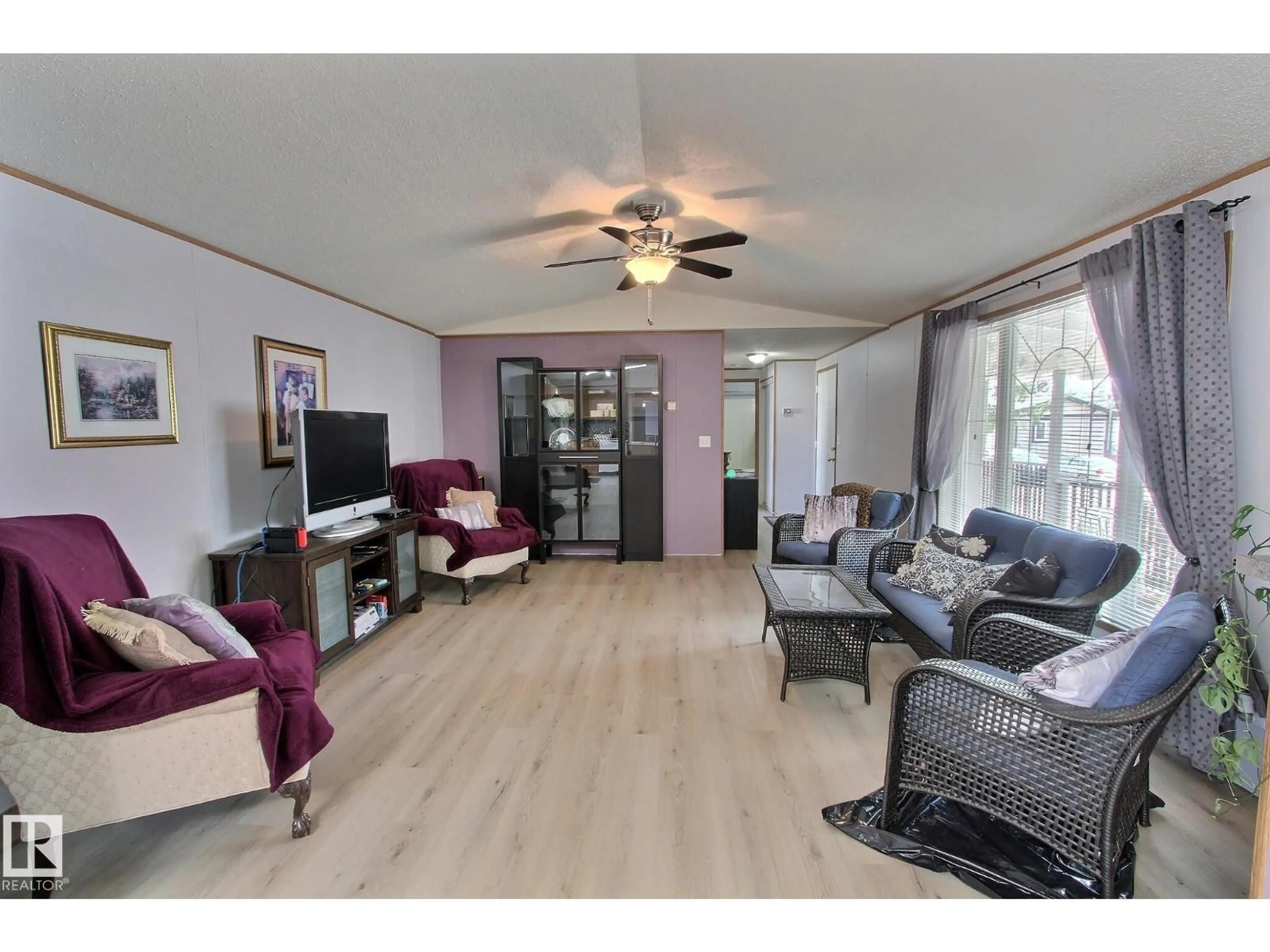 Living room with furniture, wood/laminate floor for 446 - 53222 RR 272, Rural Parkland County Alberta T7X3P6