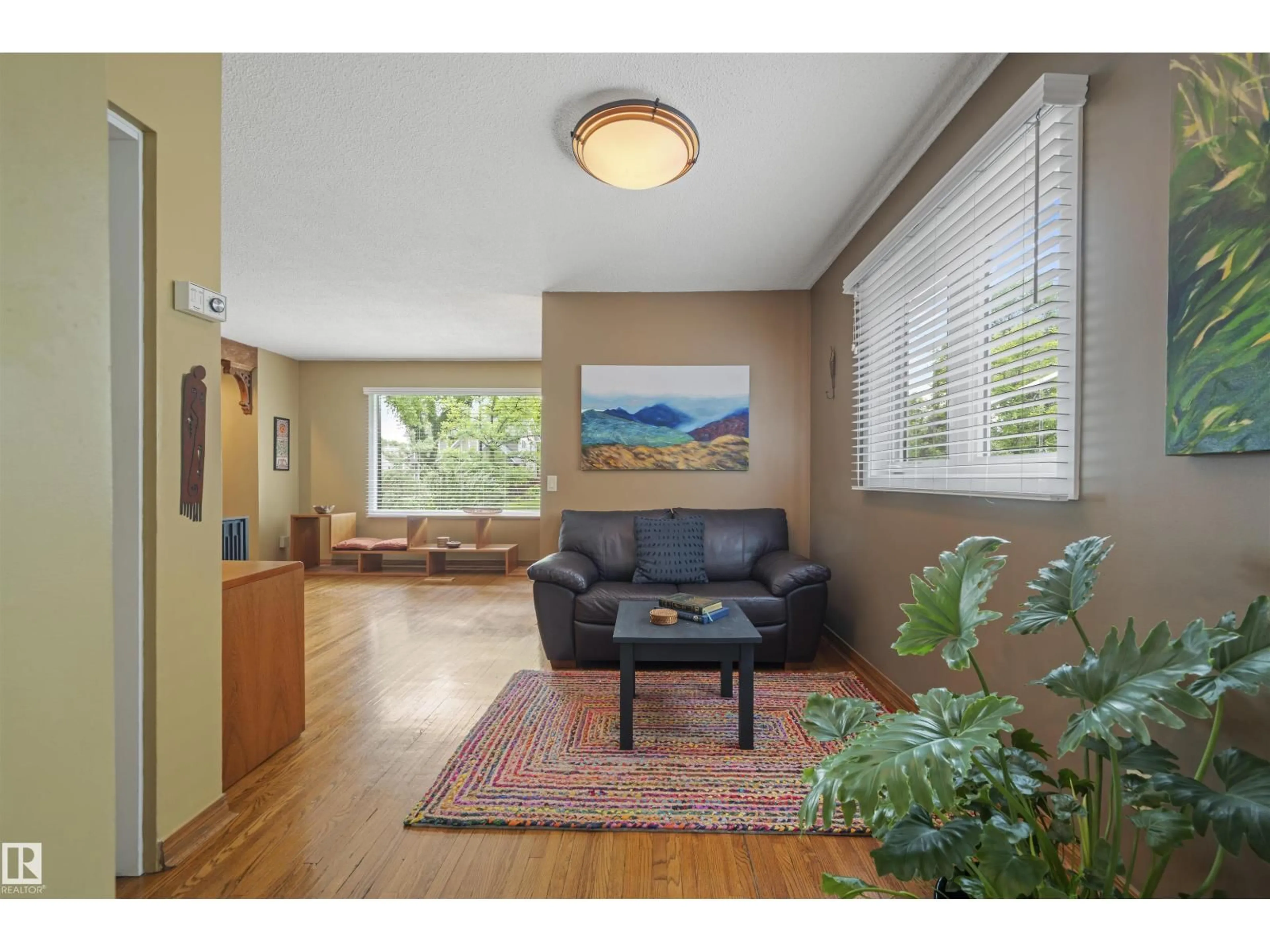 Living room with furniture, wood/laminate floor for 11622 76 AV, Edmonton Alberta T6G0K8