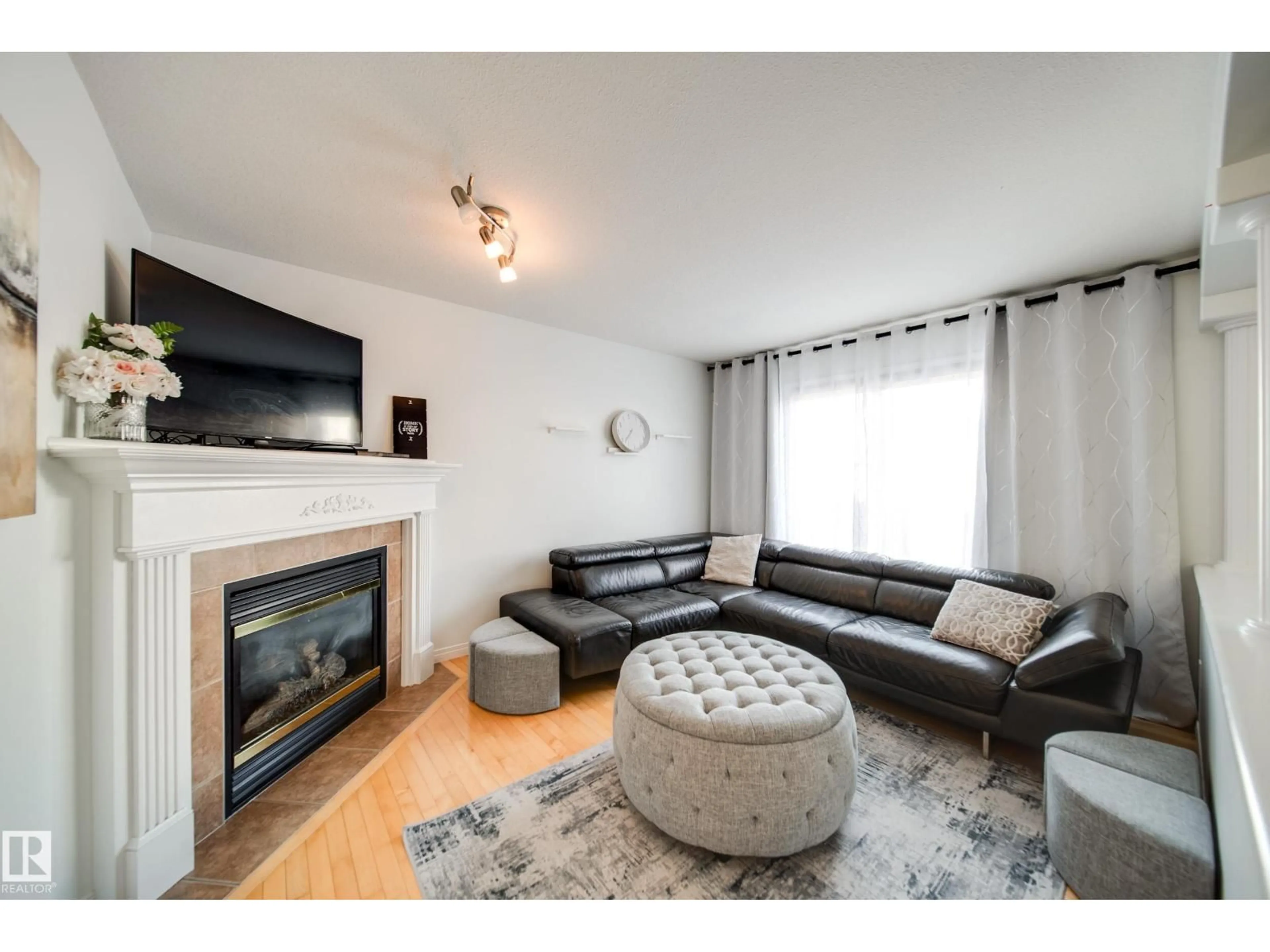 Living room with furniture, wood/laminate floor for NW - 3716 160A AV, Edmonton Alberta T5Y3G1