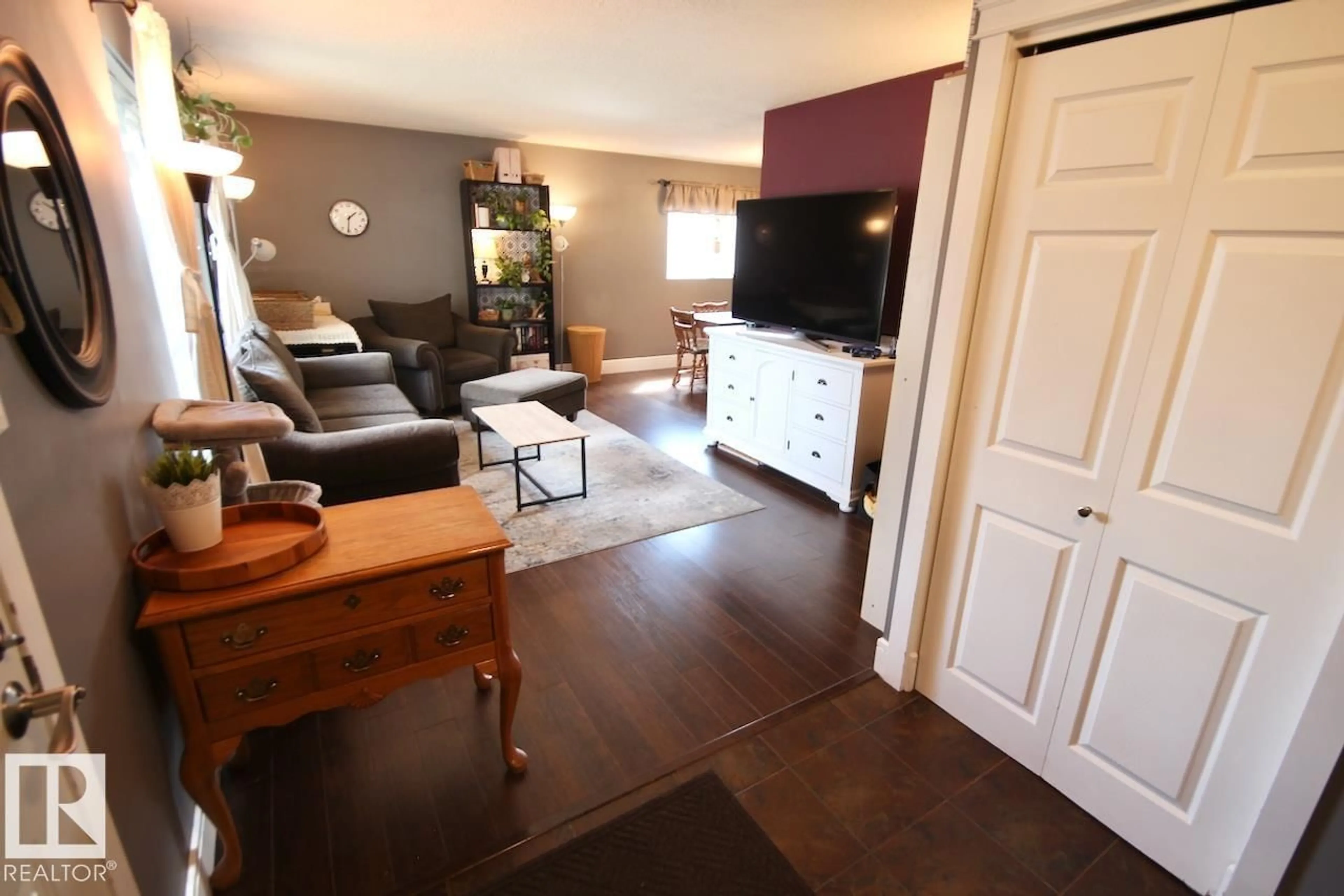 Living room with furniture, wood/laminate floor for 8607 35A AV, Edmonton Alberta T6K0C3