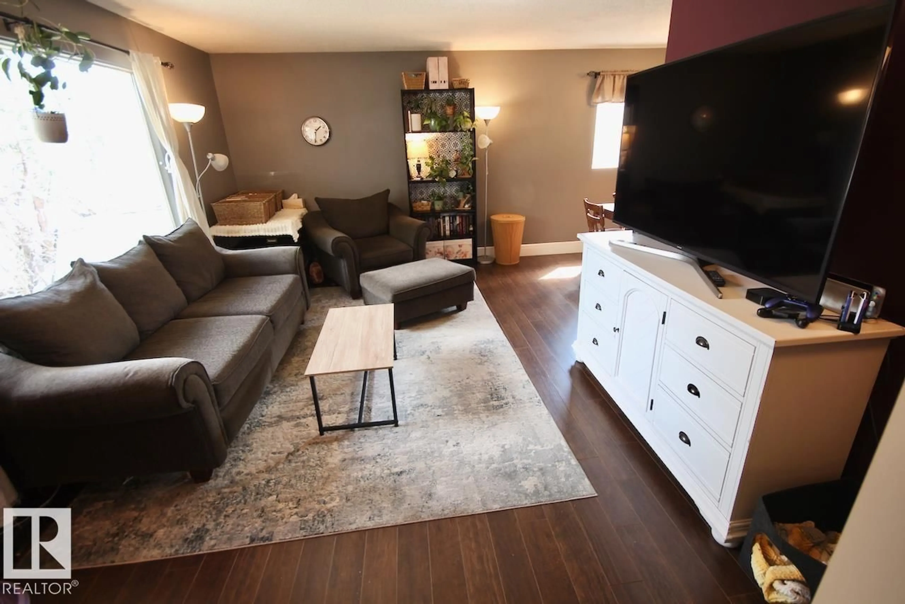 Living room with furniture, wood/laminate floor for 8607 35A AV, Edmonton Alberta T6K0C3