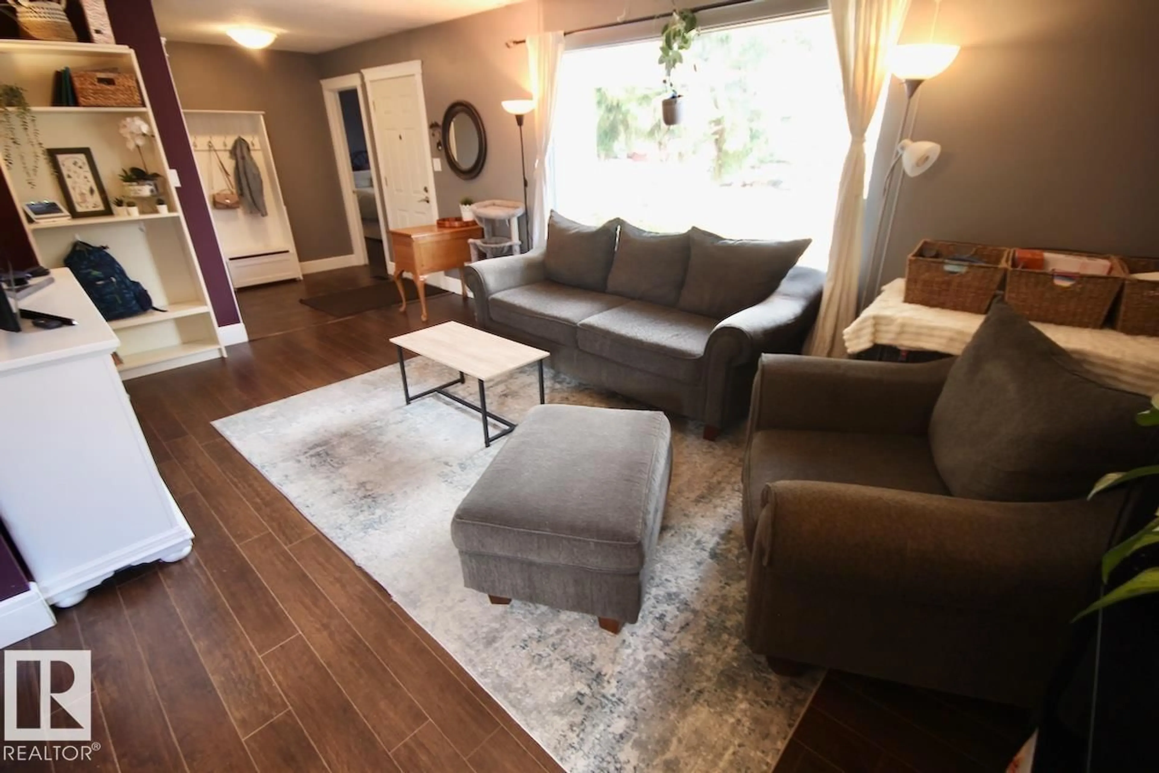 Living room with furniture, wood/laminate floor for 8607 35A AV, Edmonton Alberta T6K0C3