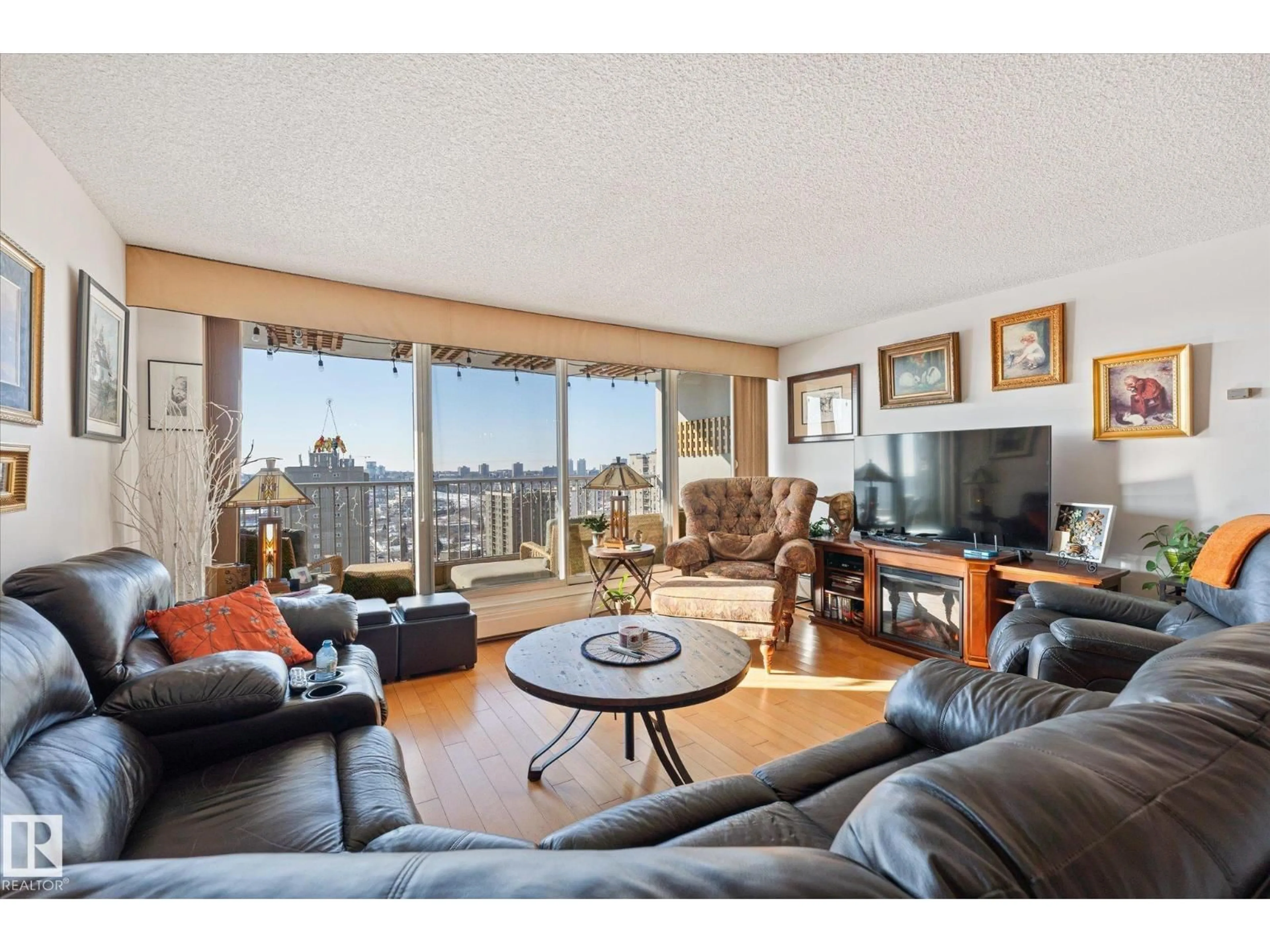 Living room with furniture, wood/laminate floor for 9923 103 ST, Edmonton Alberta T5K2J3