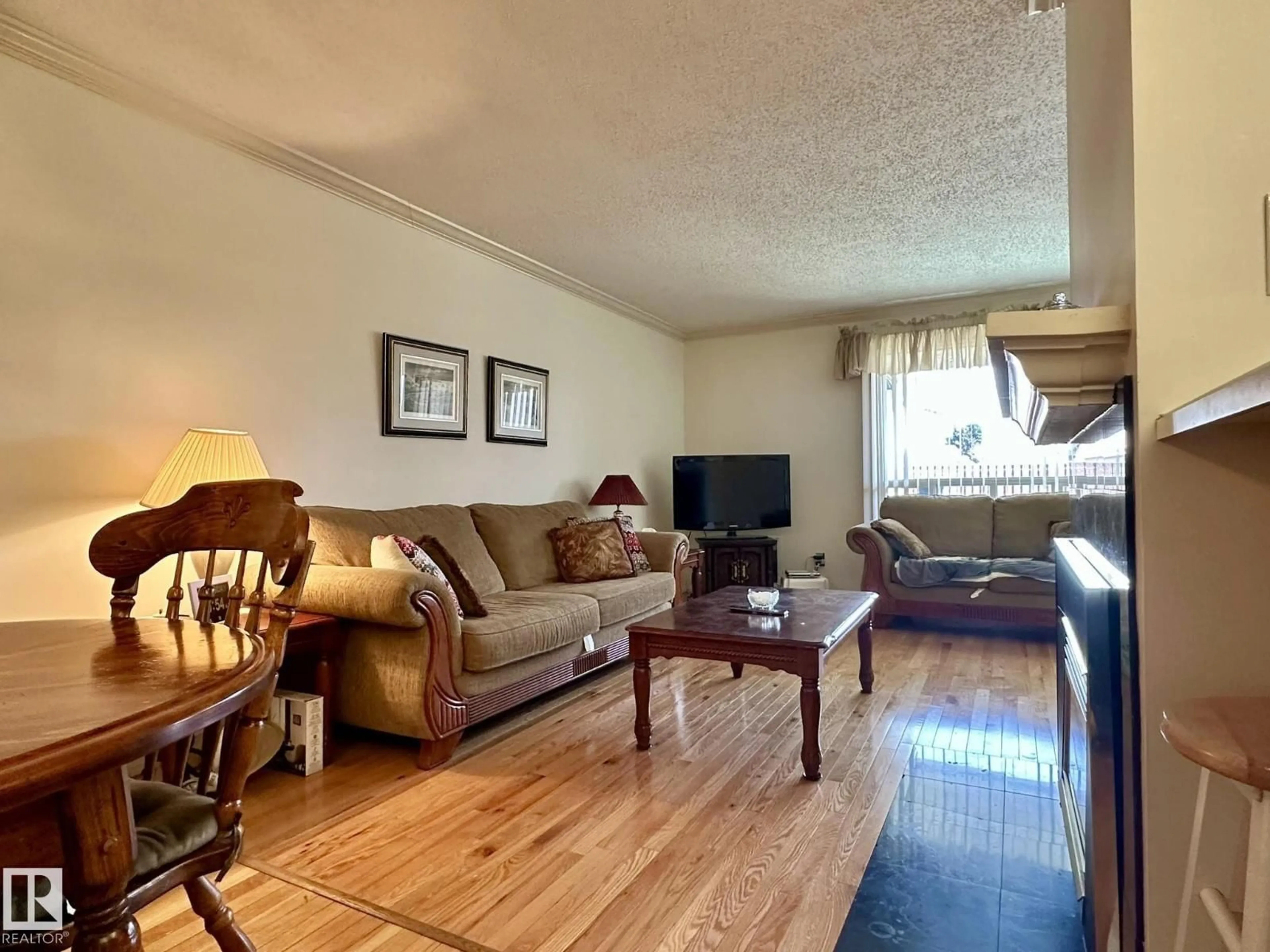 Living room with furniture, wood/laminate floor for NW - 2304 151 AV, Edmonton Alberta T5Y2L1