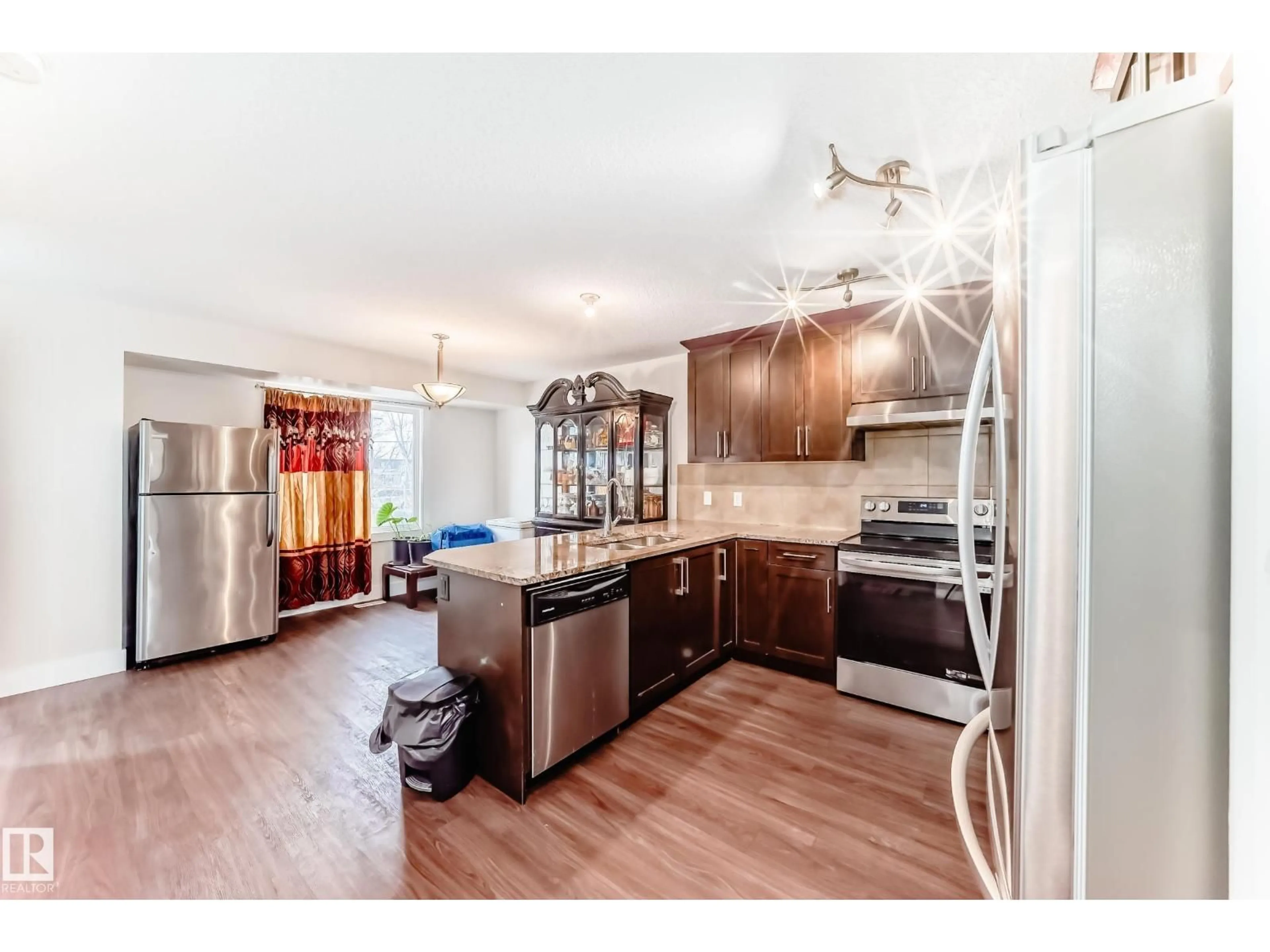 Open concept kitchen, wood/laminate floor for NW - 11732 123 ST, Edmonton Alberta T5M0G9
