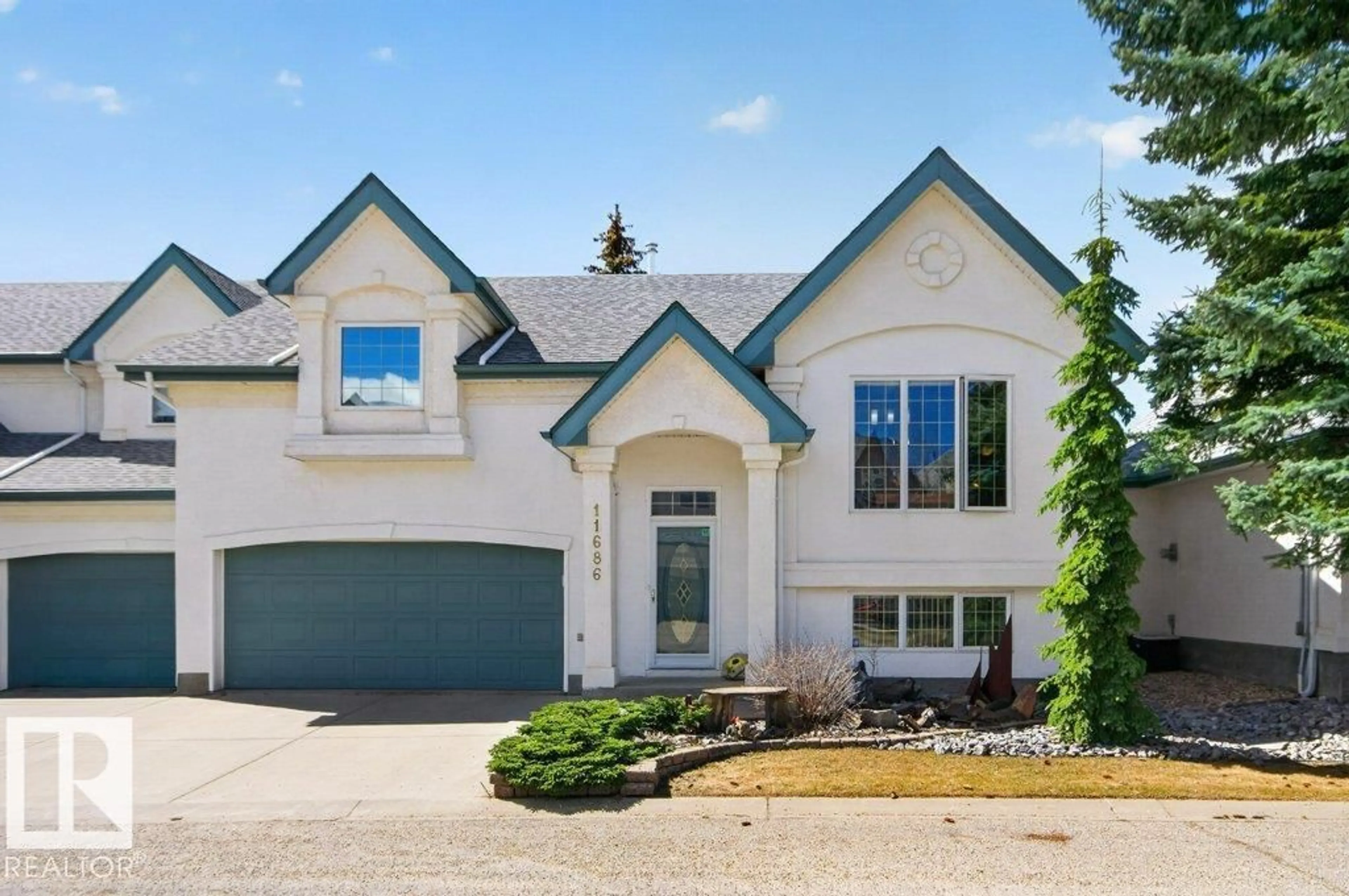 Home with vinyl exterior material, street for NW - 11686 15 AV, Edmonton Alberta T6J7E1