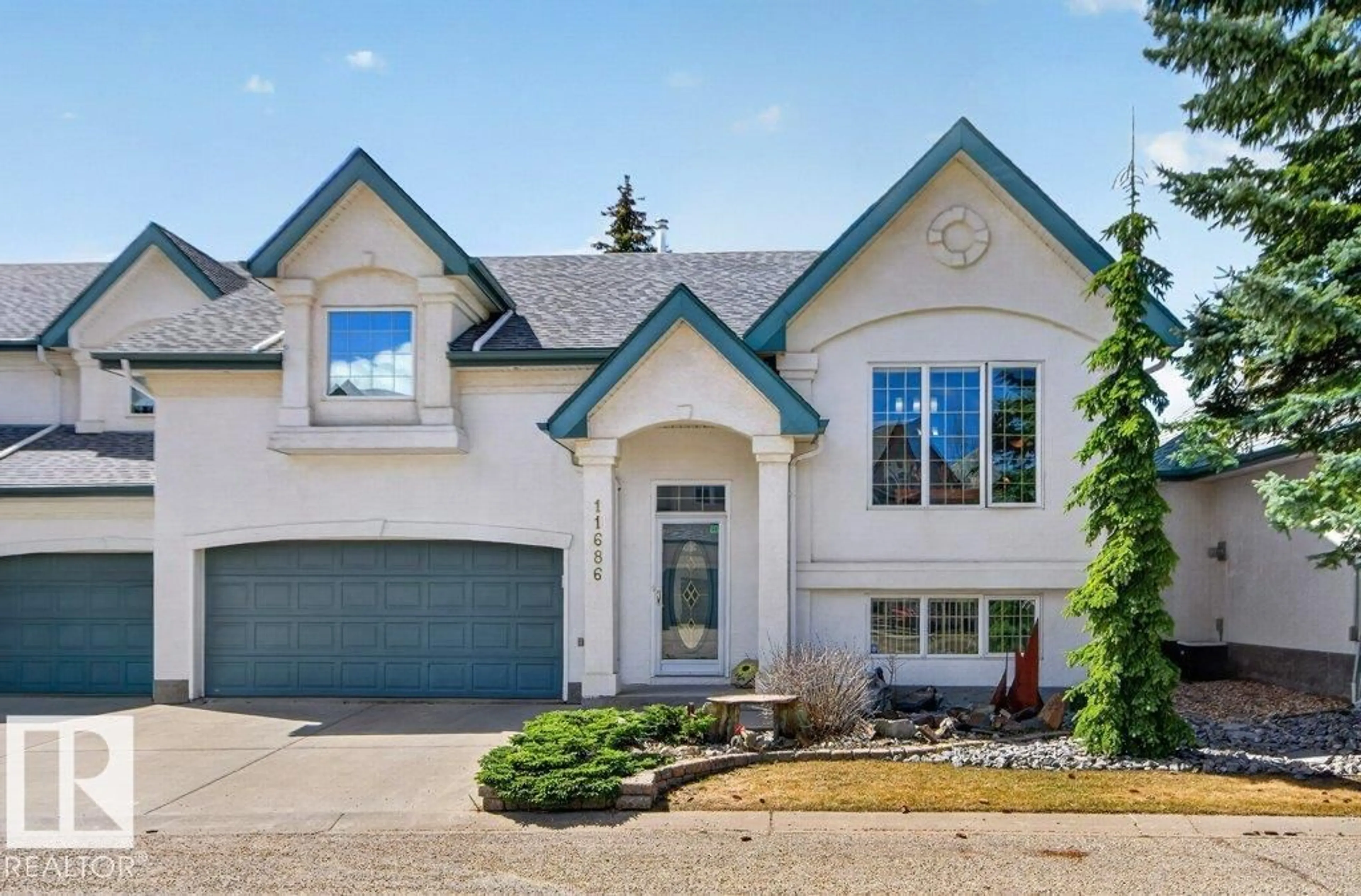 Home with vinyl exterior material, street for NW - 11686 15 AV, Edmonton Alberta T6J7E1