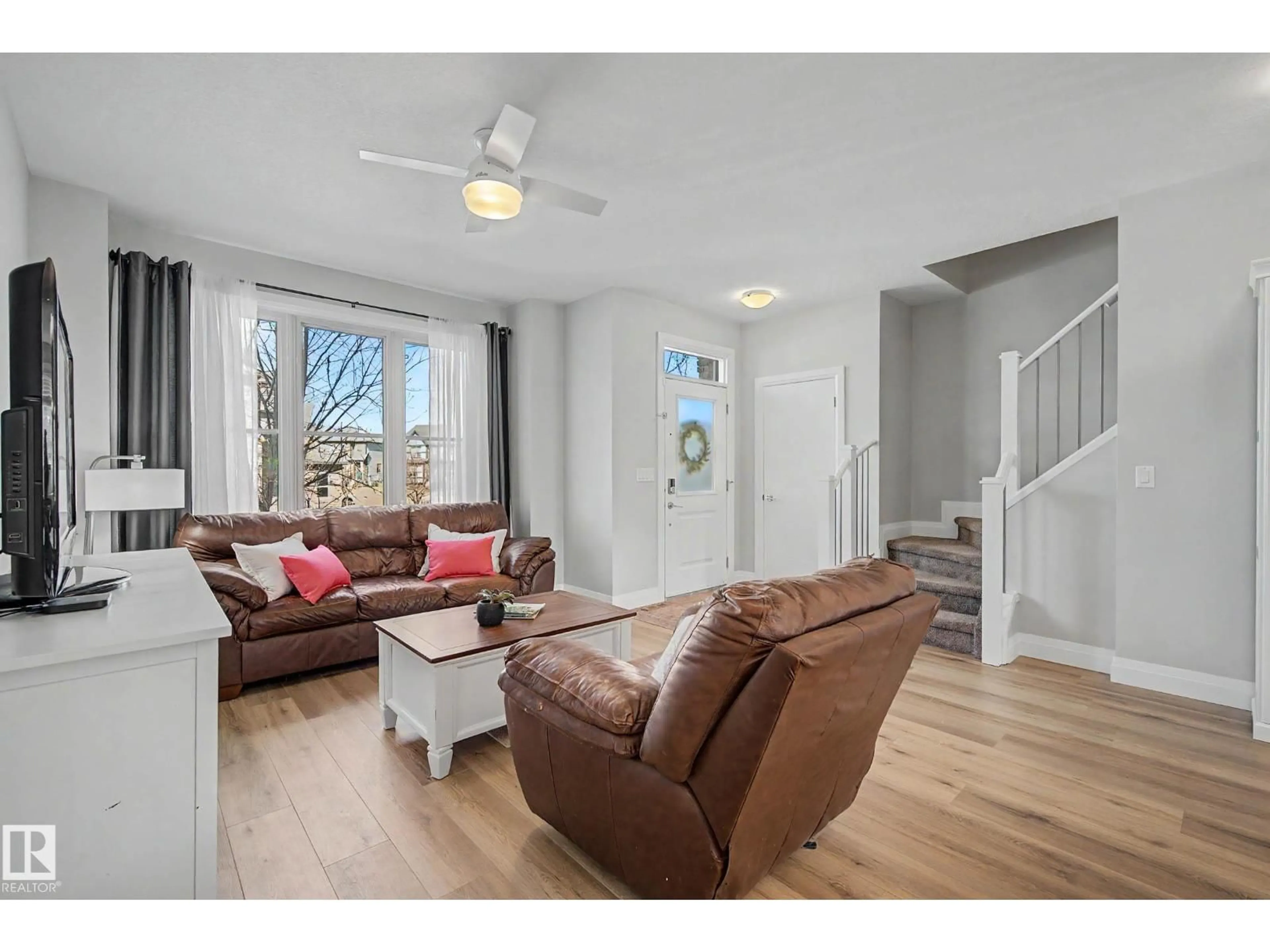 Living room with furniture, wood/laminate floor for 82 GILMORE WY, Spruce Grove Alberta T7X0M5