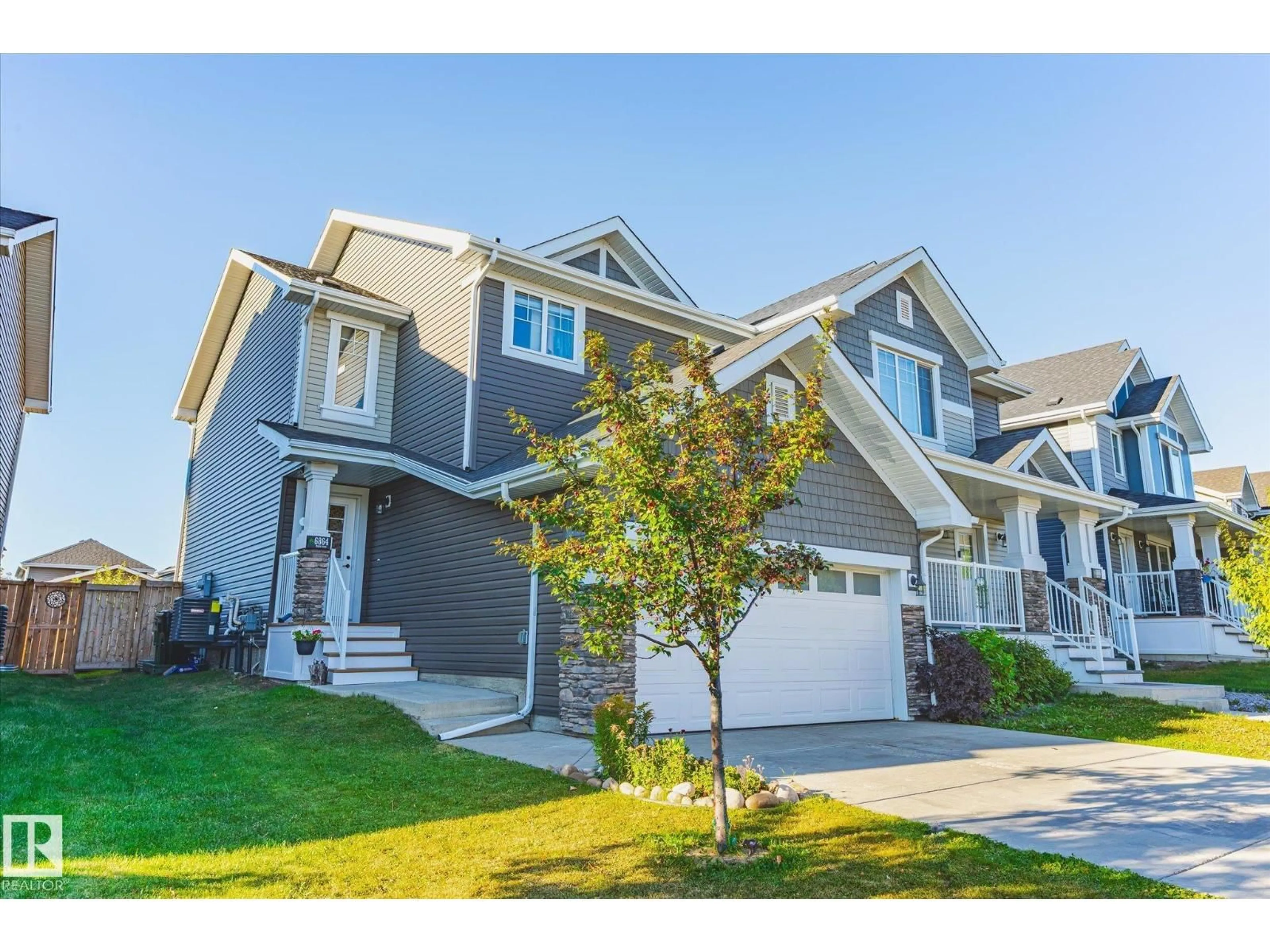 Home with vinyl exterior material, street for 6864 EVANS WD, Edmonton Alberta T6M0T6