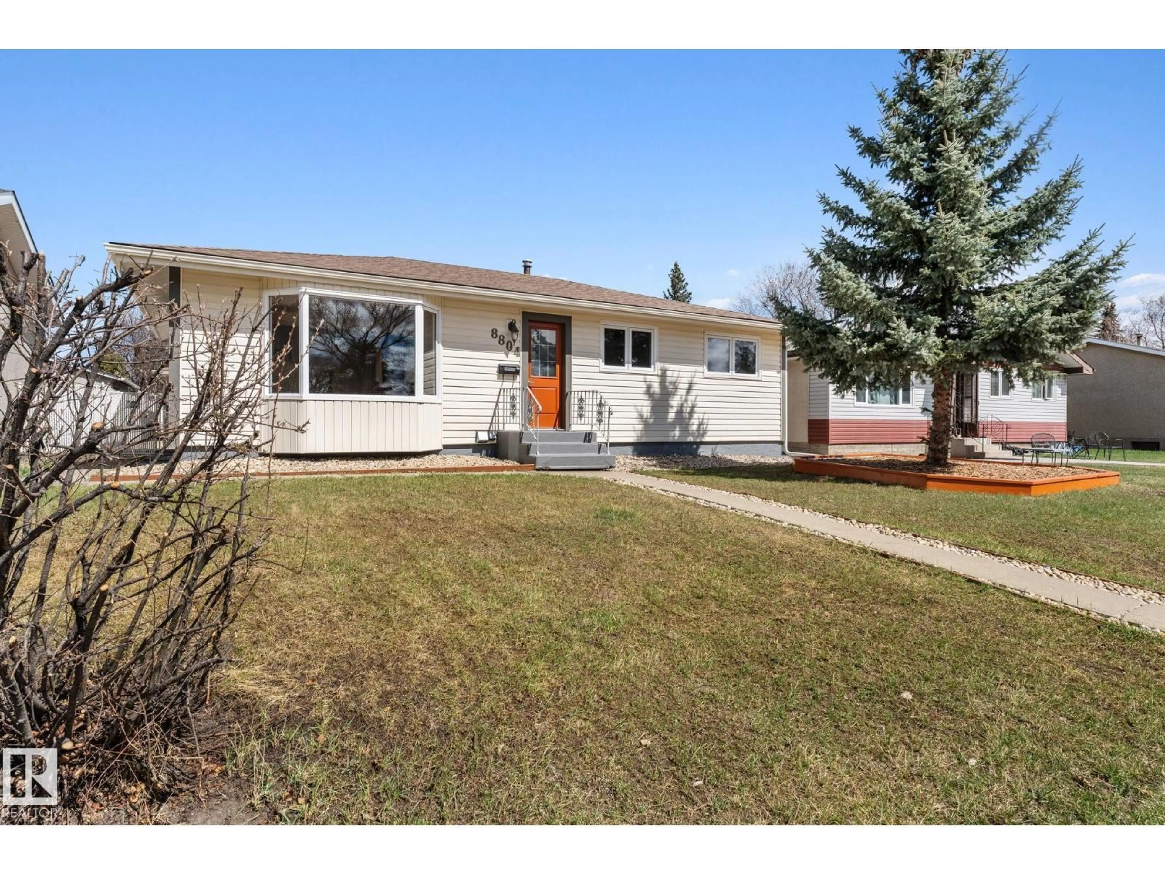 Home with vinyl exterior material, street for 8804 135 AV, Edmonton Alberta T5E1N3